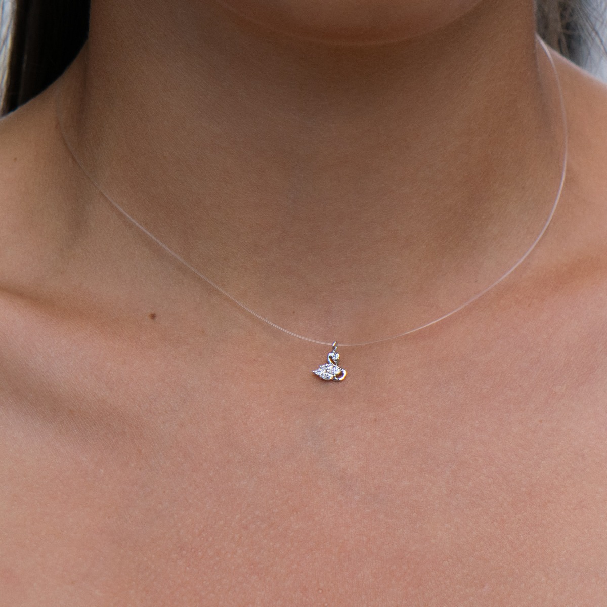 A charming necklace model, an offer from the new BirSe collection. The swan pendant is made of rhodium-plated silver, with exquisite wings of sparkling zircons. The chain has been replaced with a fine cord.