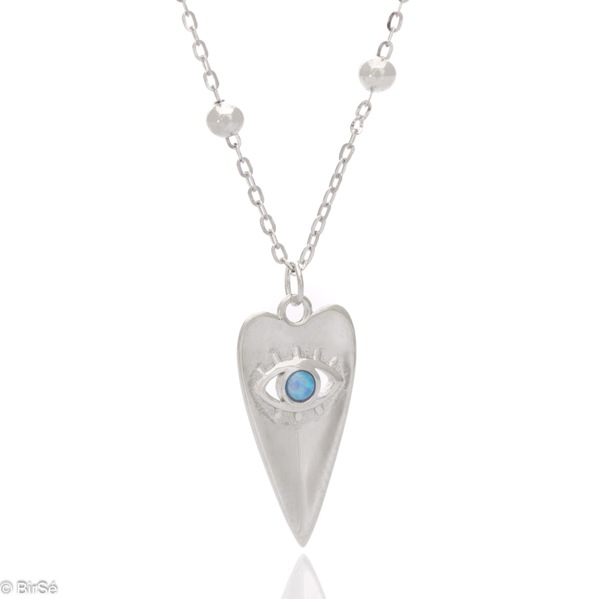 A spectacular necklace, made of fine rhodium-plated silver on a delicate chain, elegantly decorated with silver balls. A delicate heart-shaped pendant and a beautifully shaped blue eye are the main focus of the necklace.