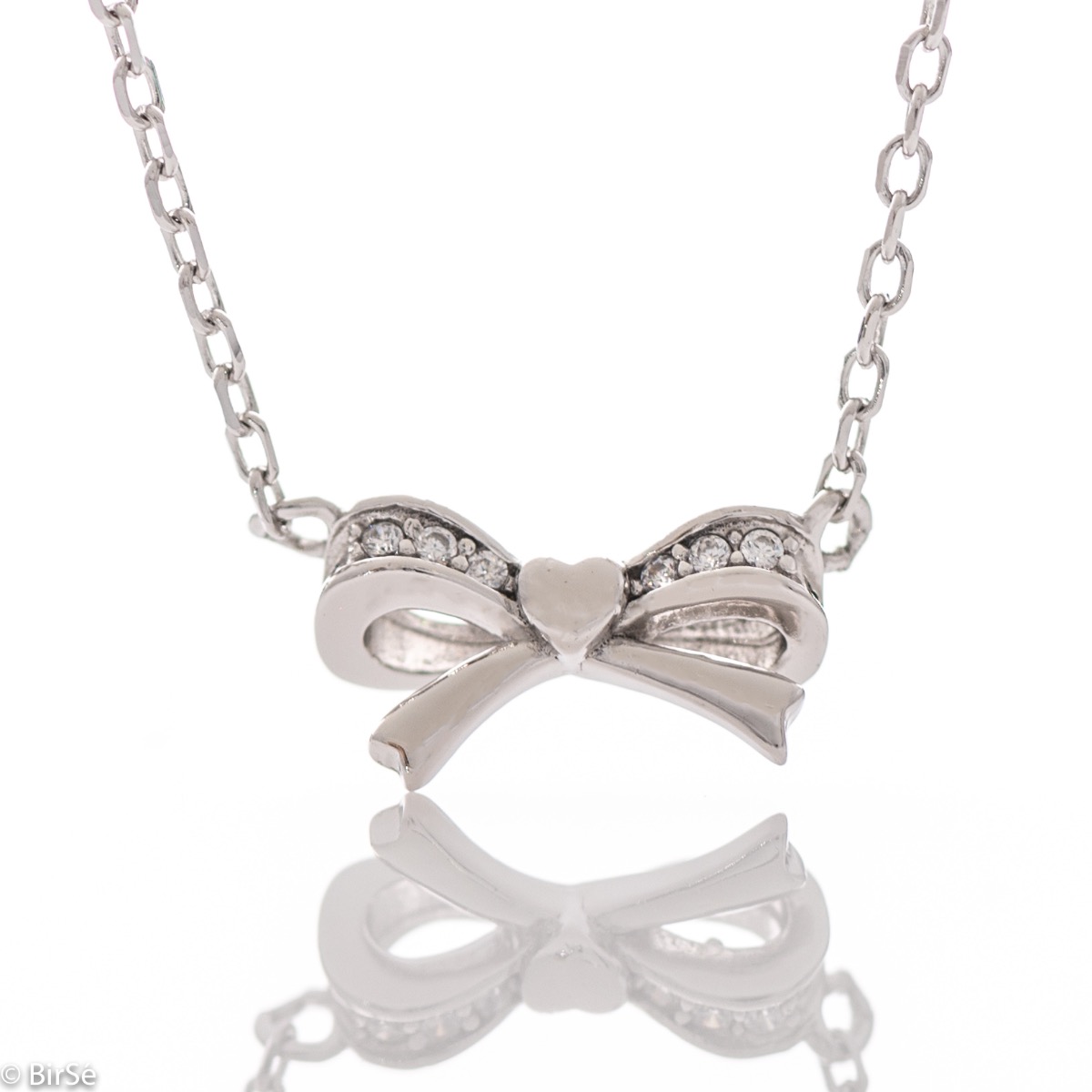 A fine sterling silver necklace with a dainty element of a small heart ribbon, made entirely of lustrous rhodium silver.