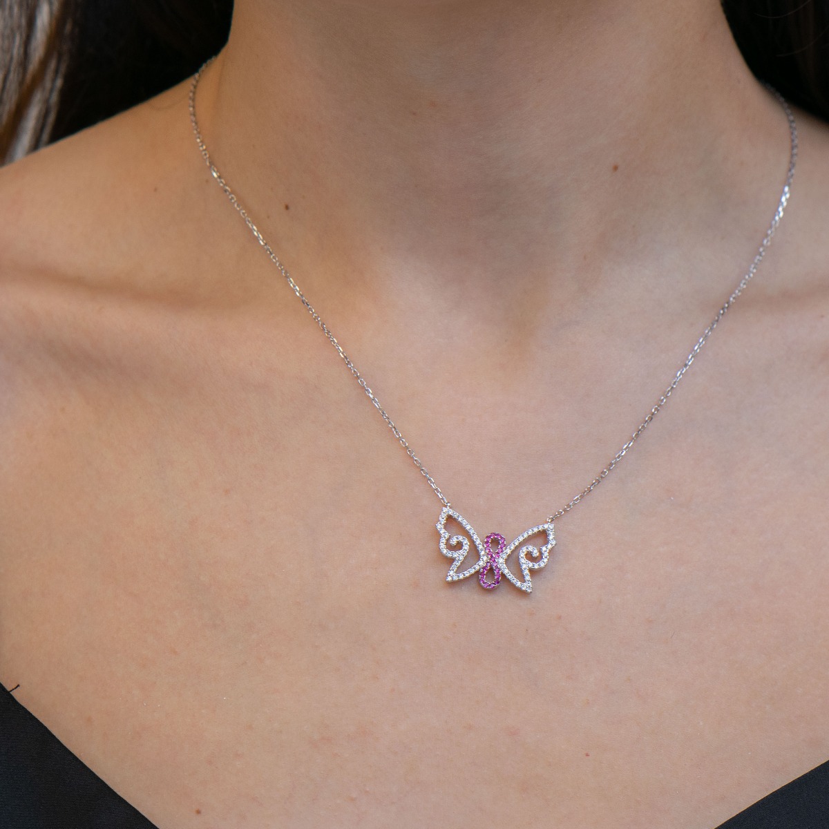 Butterfly and infinity - the necklace carries the symbolism of the endless quest for free flight and a sunny idyll. Beautifully crafted from soft rhodium silver and glittering zircons.