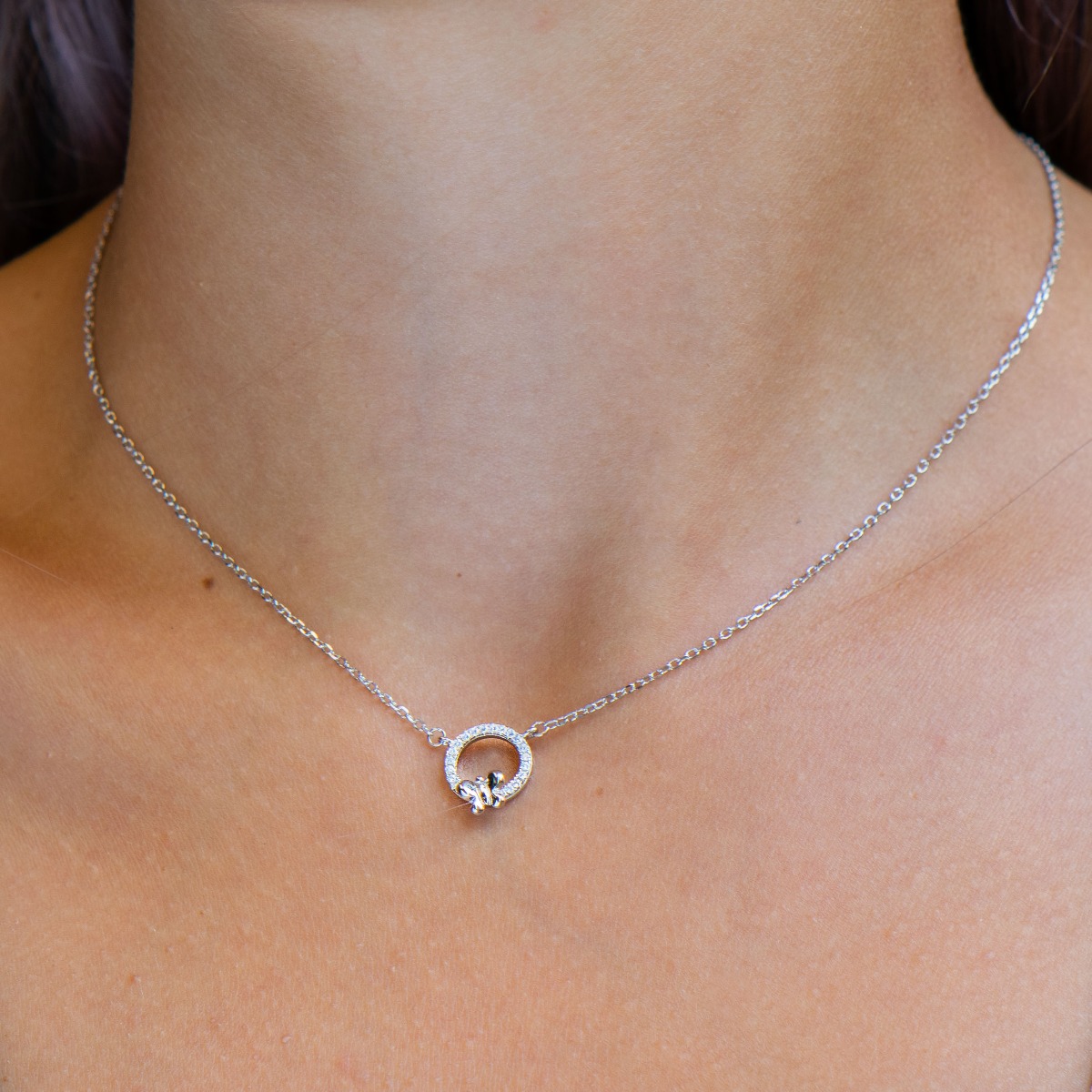 A lovely necklace of soft rhodium-plated silver, with an elegantly shaped circle, all covered with glittering zircons. A small, delicate butterfly is perched timidly on the stones. The necklace is an ideal gift to please a friend or beloved woman.