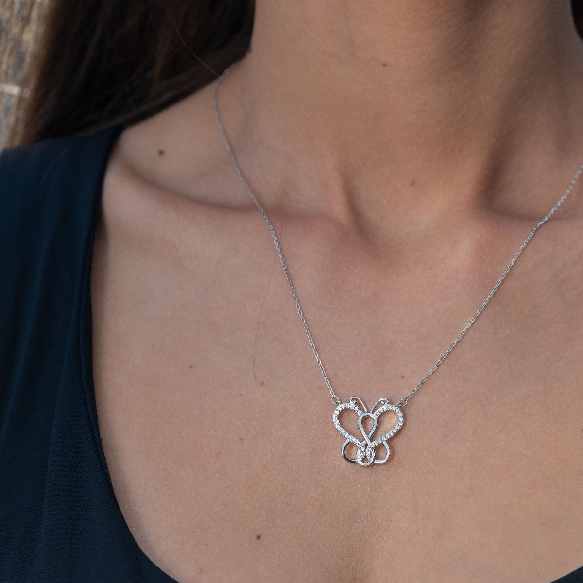 A delicate women's necklace with precision craftsmanship entirely of rhodium-plated silver, complemented by sparkling zircons and an exquisite butterfly shape.