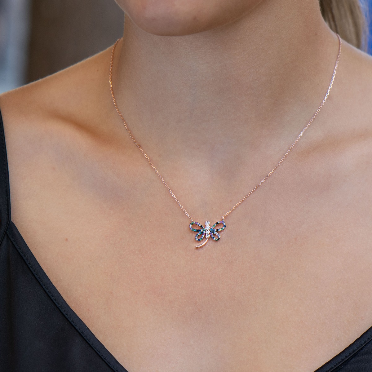 A fabulously beautiful necklace made of rhodium-plated rose silver - a lovely dragonfly, with wings studded with multi-colored glittering zircons.