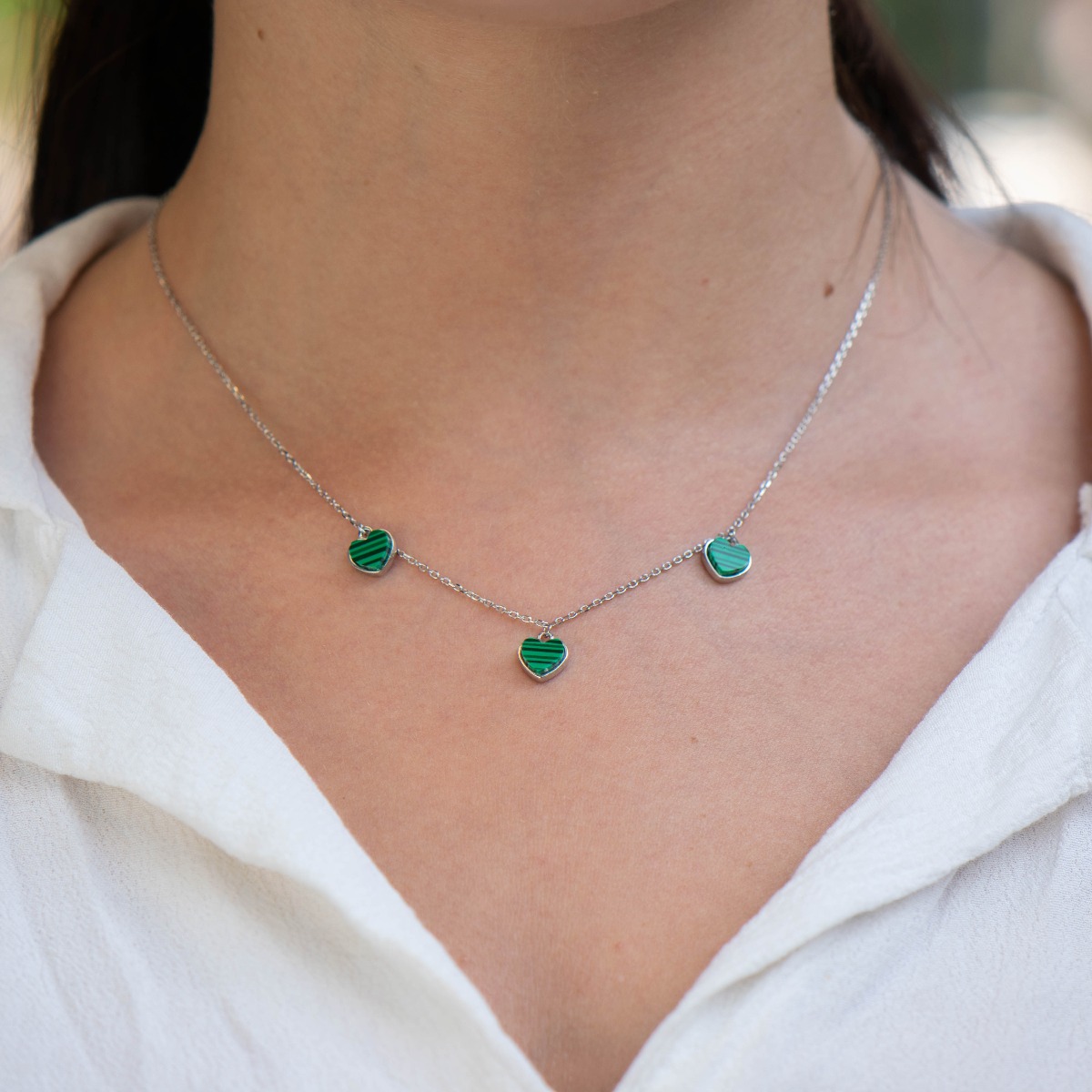 Exquisitely crafted women's necklace of fine rhodium silver, with beautifully shaped pendants - hearts of magnetic malachite.