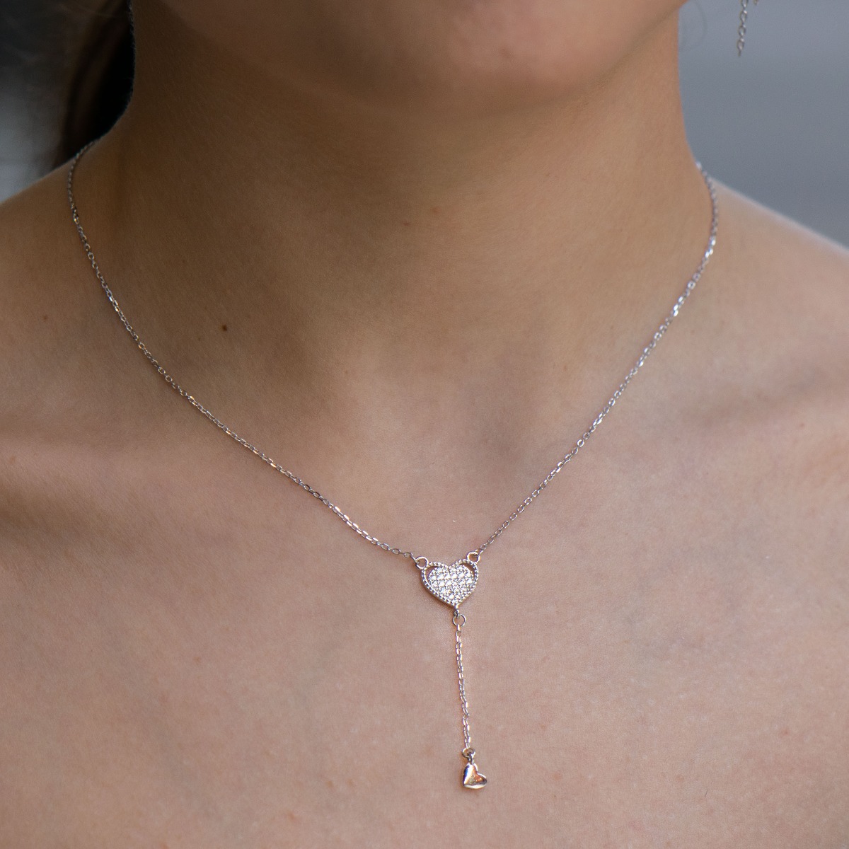 Elegant silver necklace - Heart, made of rhodium-plated silver. A pendant with a smaller delicate heart is placed under an elegant heart, completely studded with zircons. A piece of jewelry suitable for every lady with a romantic soul and eyes in love.