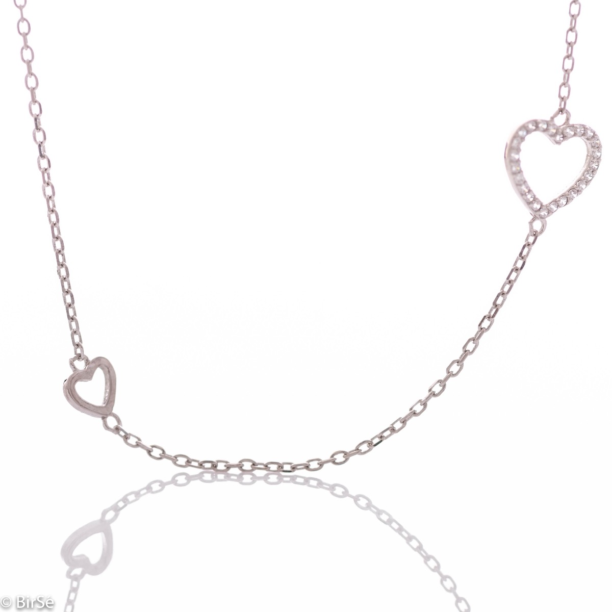 An exquisite silver necklace with precise craftsmanship entirely of rhodium-plated silver and two delicate hearts on the chain, complemented by sparkling zircons.