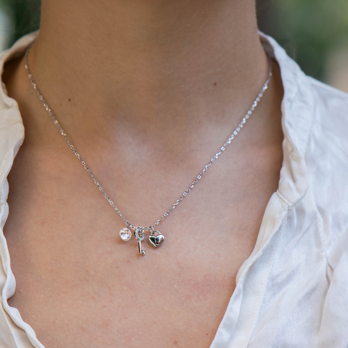 A spectacular women's necklace made of beautiful rhodium-plated silver with several pendants decorated with zircons.  The necklace has an extension for greater convenience in adjusting the size.