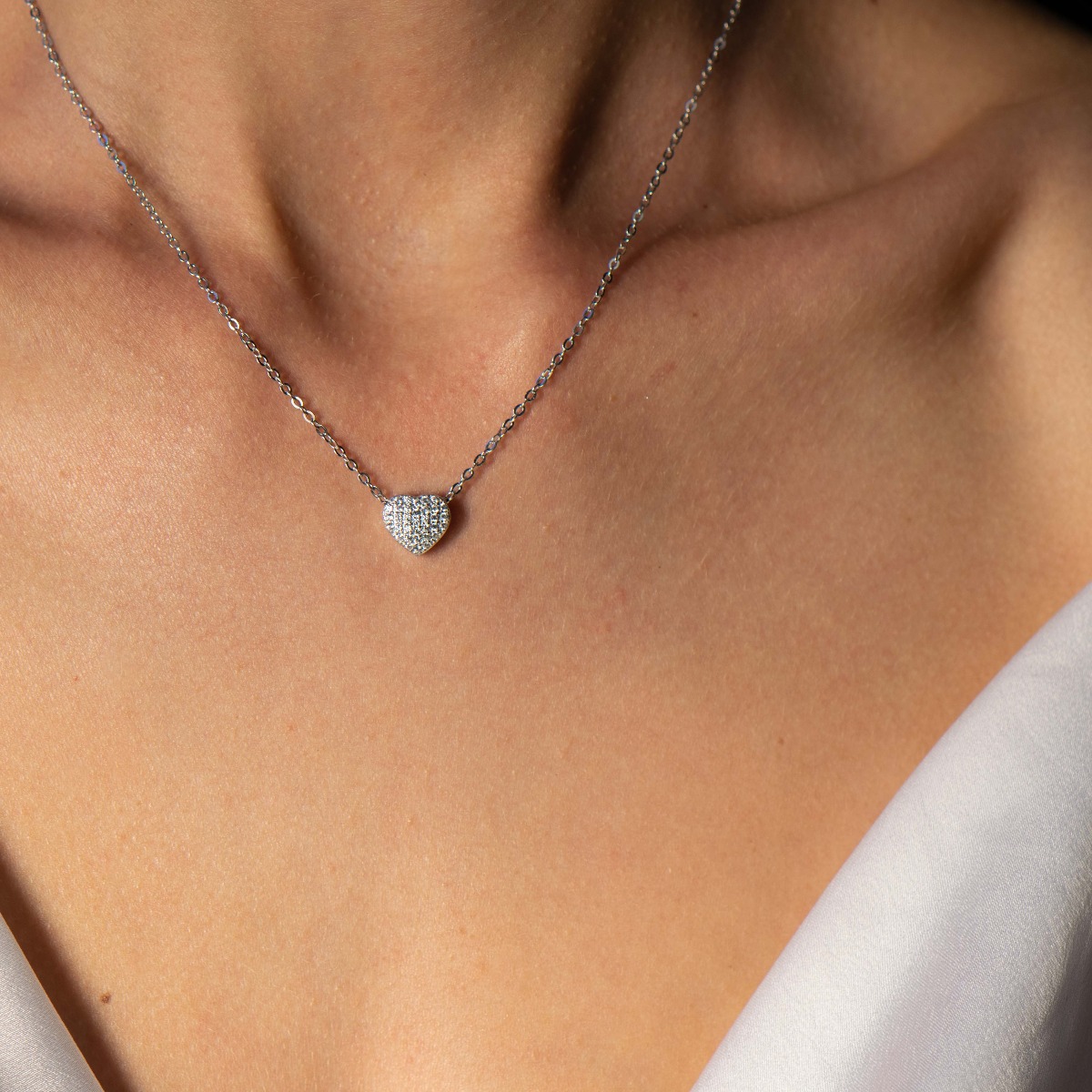 A stylish and delicate ladies' necklace with a fine rhodium-plated silver design and a small heart shape, studded with sparkling zircons. Suitable for everyday life.