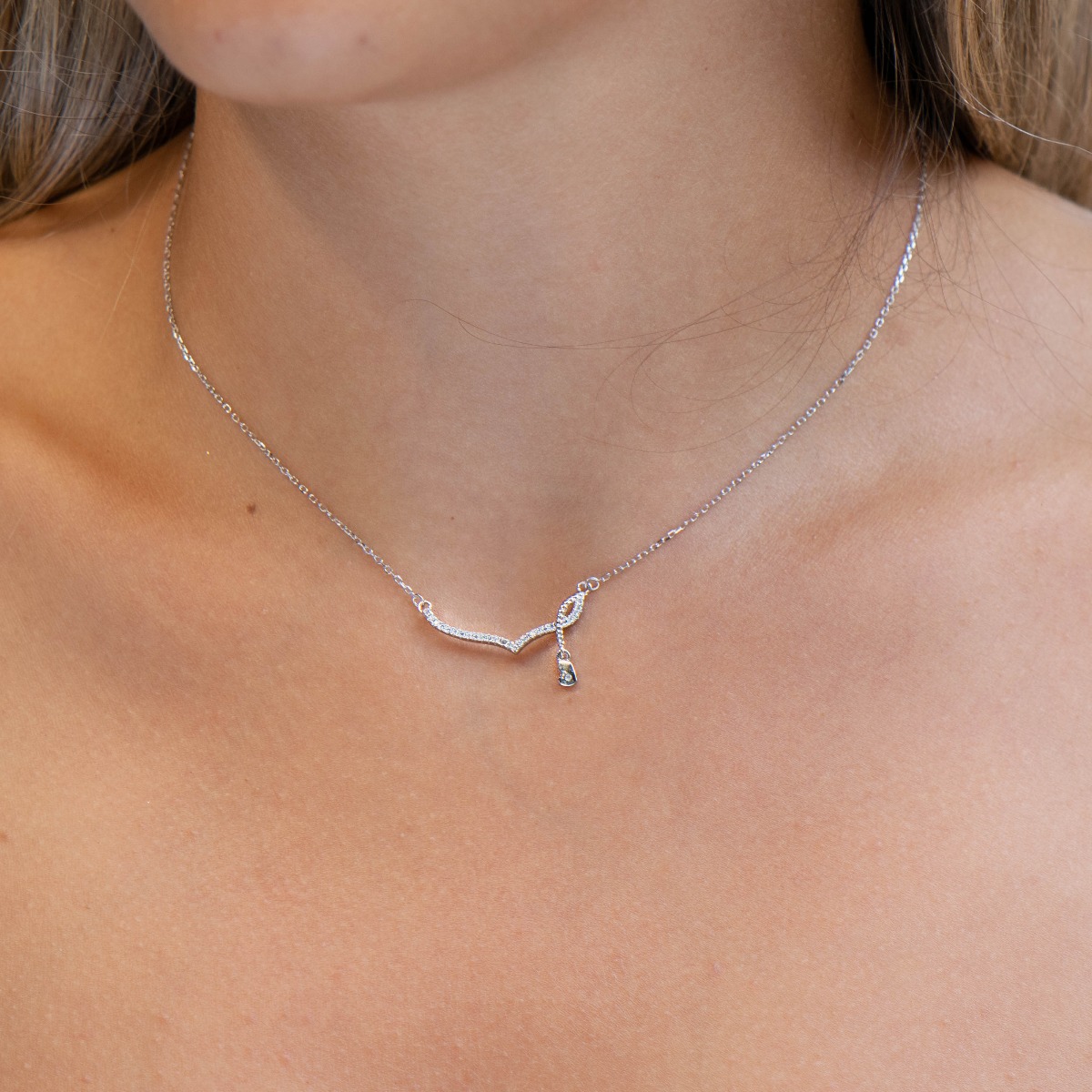 A delicate women's necklace with fine workmanship entirely of rhodium-plated silver, combined with beautiful details and sparkling zircons.