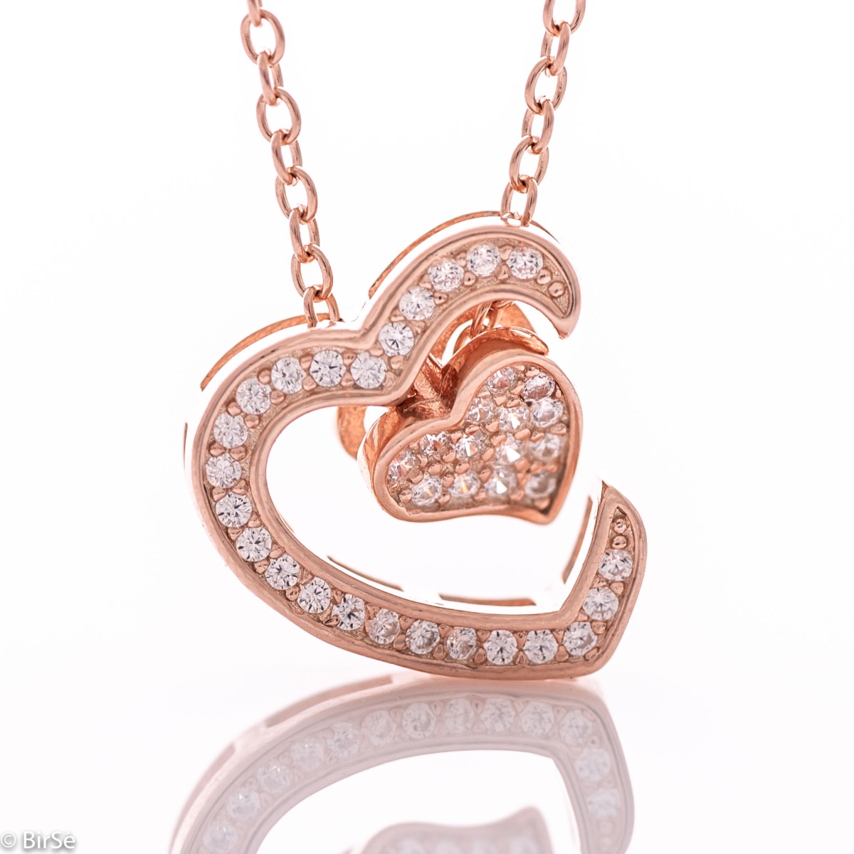 An exquisite women's necklace with precise craftsmanship combining gently rhodium-plated rose silver with glittering zircons and the shape of two beautiful hearts.