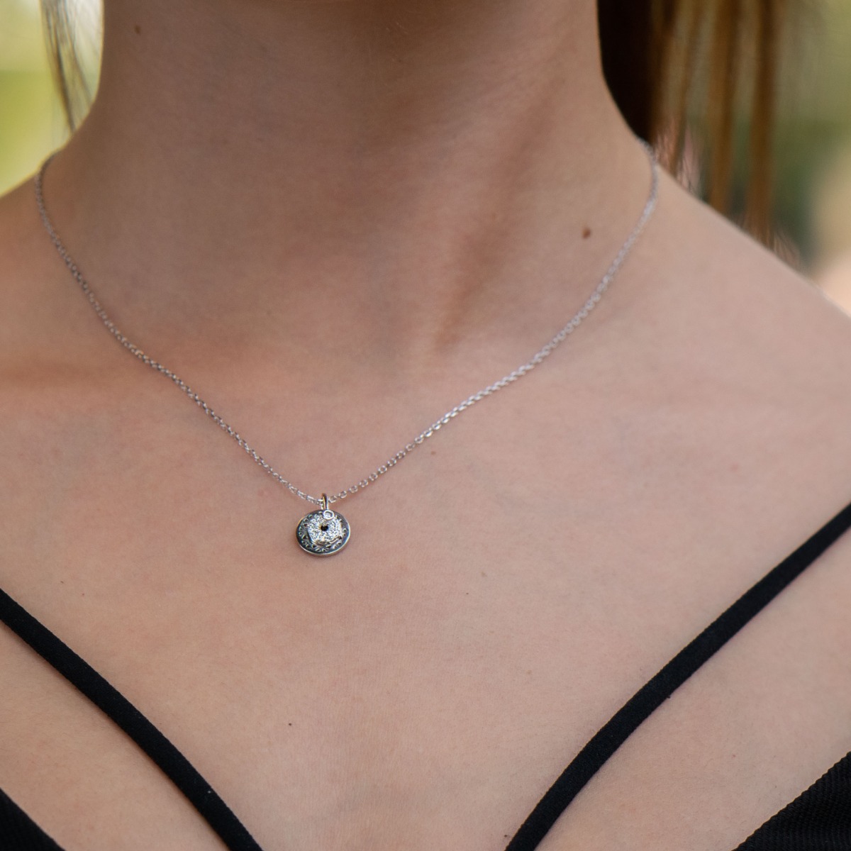 Spectacular silver necklace with delicate craftsmanship entirely of rhodium-plated silver and two fine circle elements, one studded with sparkling zircons.