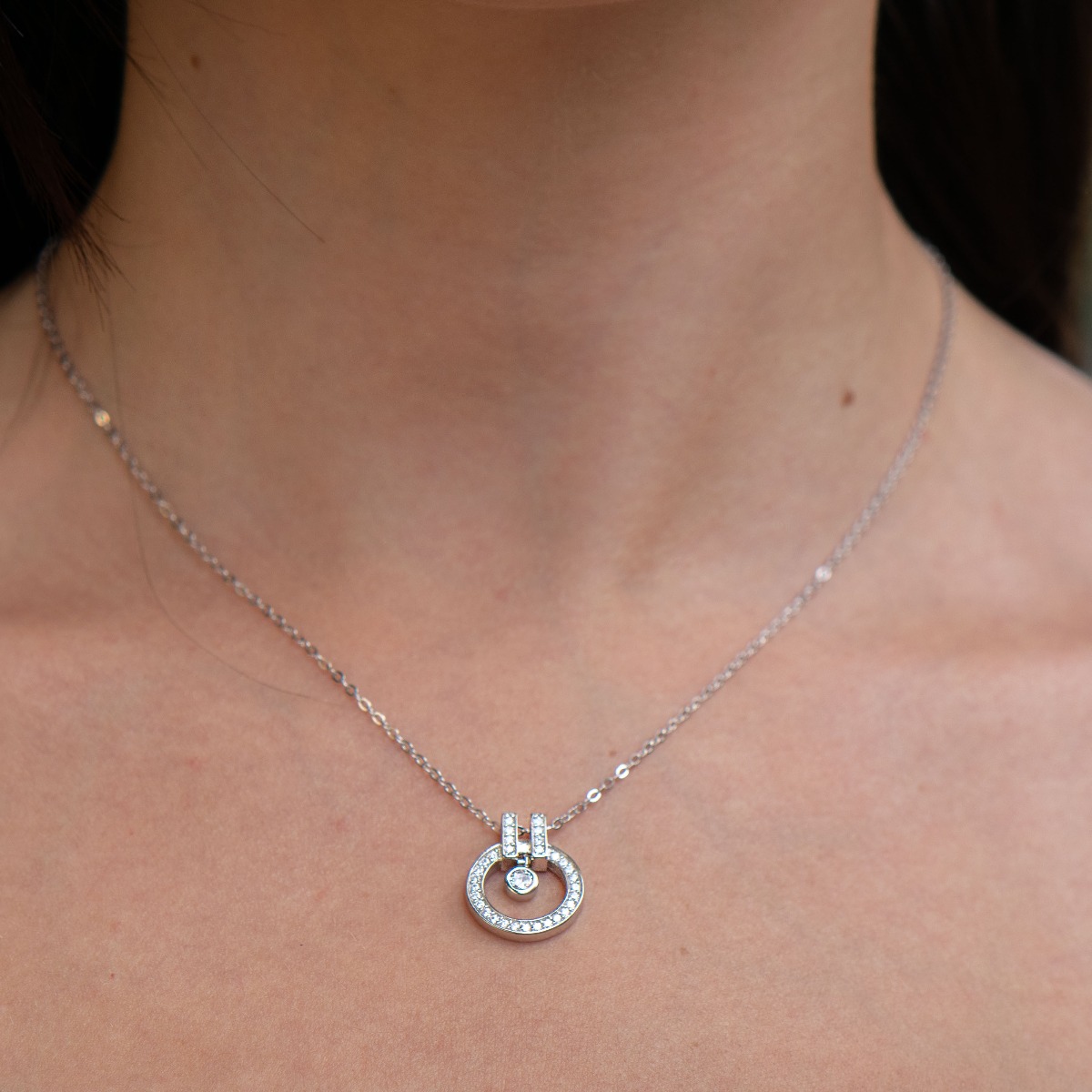 A spectacular women's necklace made of fine rhodium silver with elegantly crafted elements, exquisitely decorated with sparkling zircons. It can be combined with earrings and rings made of silver and zircons.