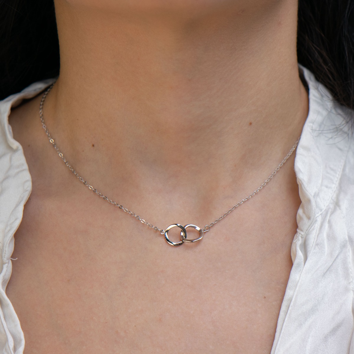 A spectacular women's necklace made of fine rhodium silver with elegantly crafted elements, exquisitely decorated with sparkling zircons. The necklace symbolizes the eternal bond that nothing can break. A suitable gift for the beloved fiancee and future w