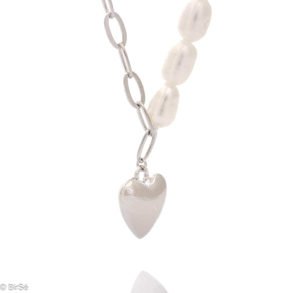 Perfectly crafted necklace for stylish ladies, executed by combining fine rhodium silver and captivating pearls charmingly covering one side of the chain. A delicate heart completes this tempting piece of jewelry, which is a perfect addition to any outfit