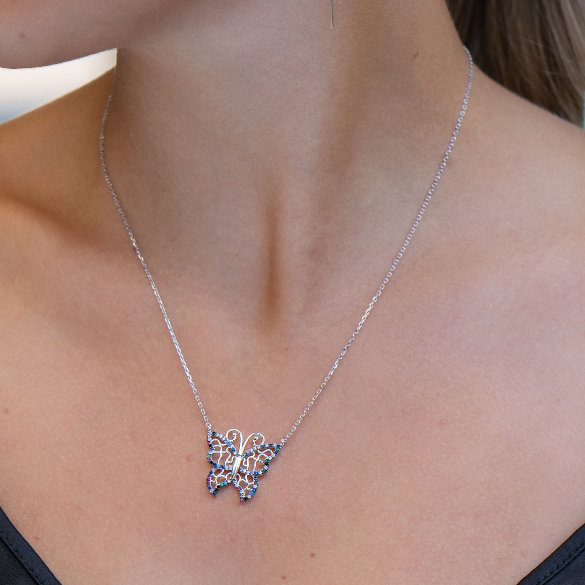 A beautiful multi-colored butterfly represents the necklace made of soft silver, with shiny multi-colored zircons, in which all the charm of a summer day is gathered.