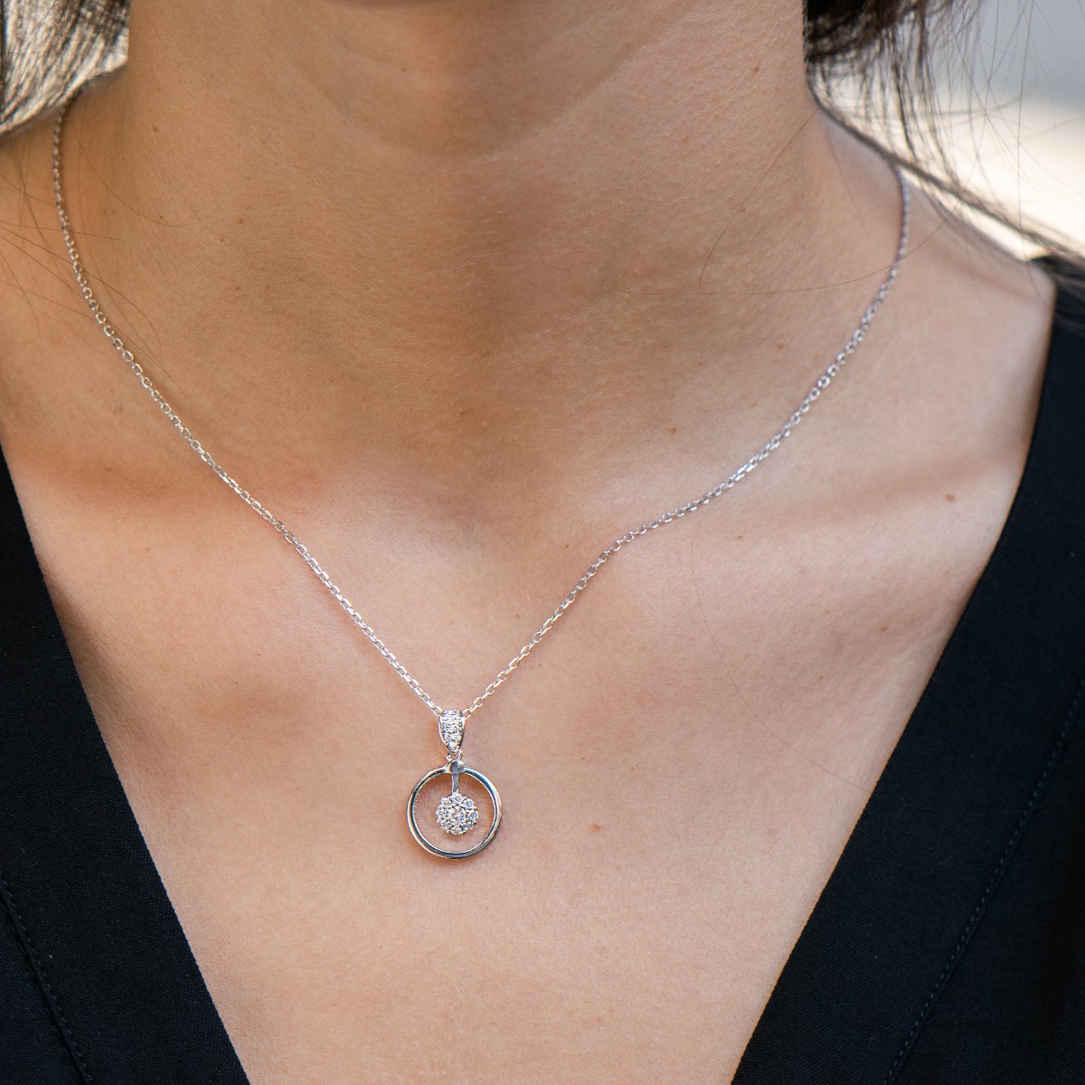 A delicate silver necklace with precise craftsmanship and an exquisite circle shape complemented by fine, sparkling zircons and rhodium-plated silver.