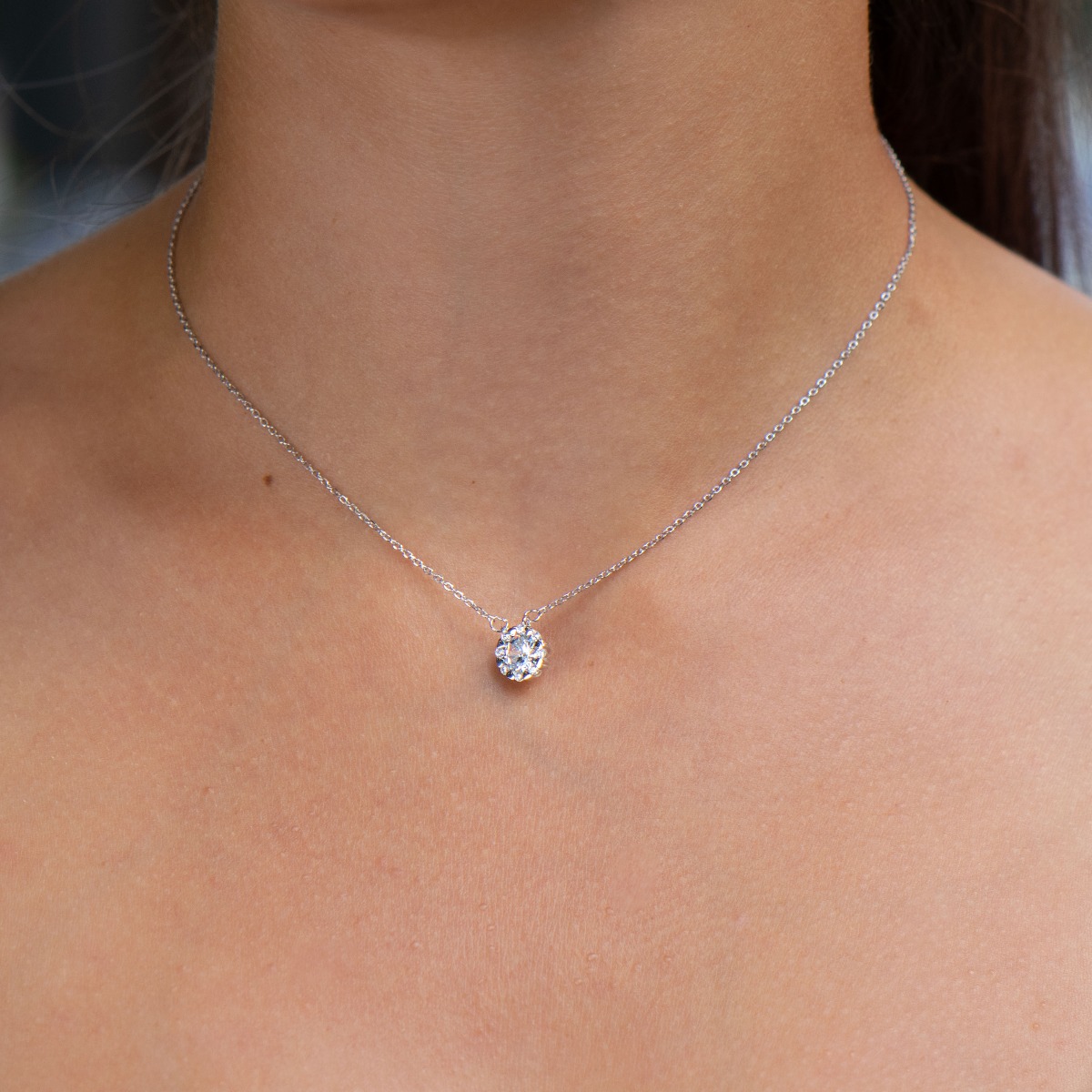 Elegant women's necklace with an exquisite design of rhodium-plated silver. The jewelry is uniquely crafted - small, delicate hearts attach a dazzling zircon, while other delicate zircons add even more sparkle and charm.