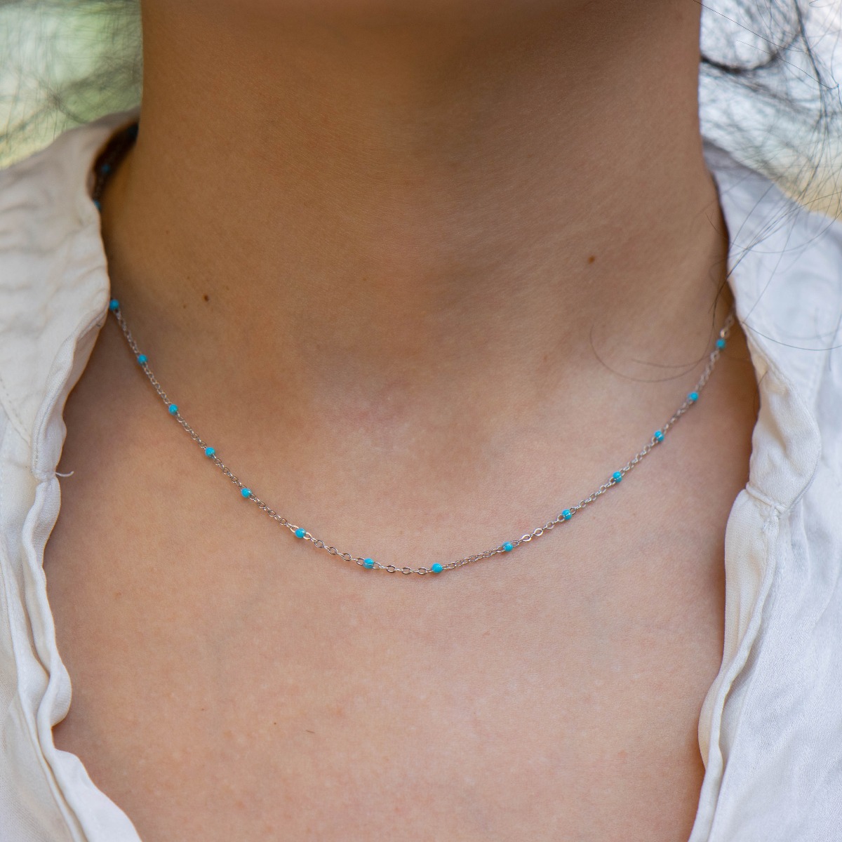 Delightfully delicate women's necklace in fine rhodium silver and delicate blue turquoise beads that add an exotic nautical flavor to the jewelry. Can be combined with a matching bracelet with the same turquoise elements.