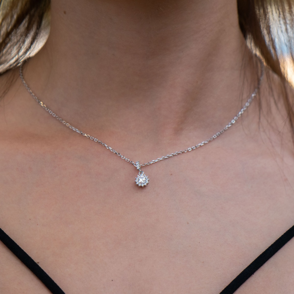 An elegant silver necklace with a delicate look and refined design. Stylish compositional design of the elements from a fine combination of rhodium-plated silver with sparkling zircon stones. It is suitable for combination with a set of silver earrings an