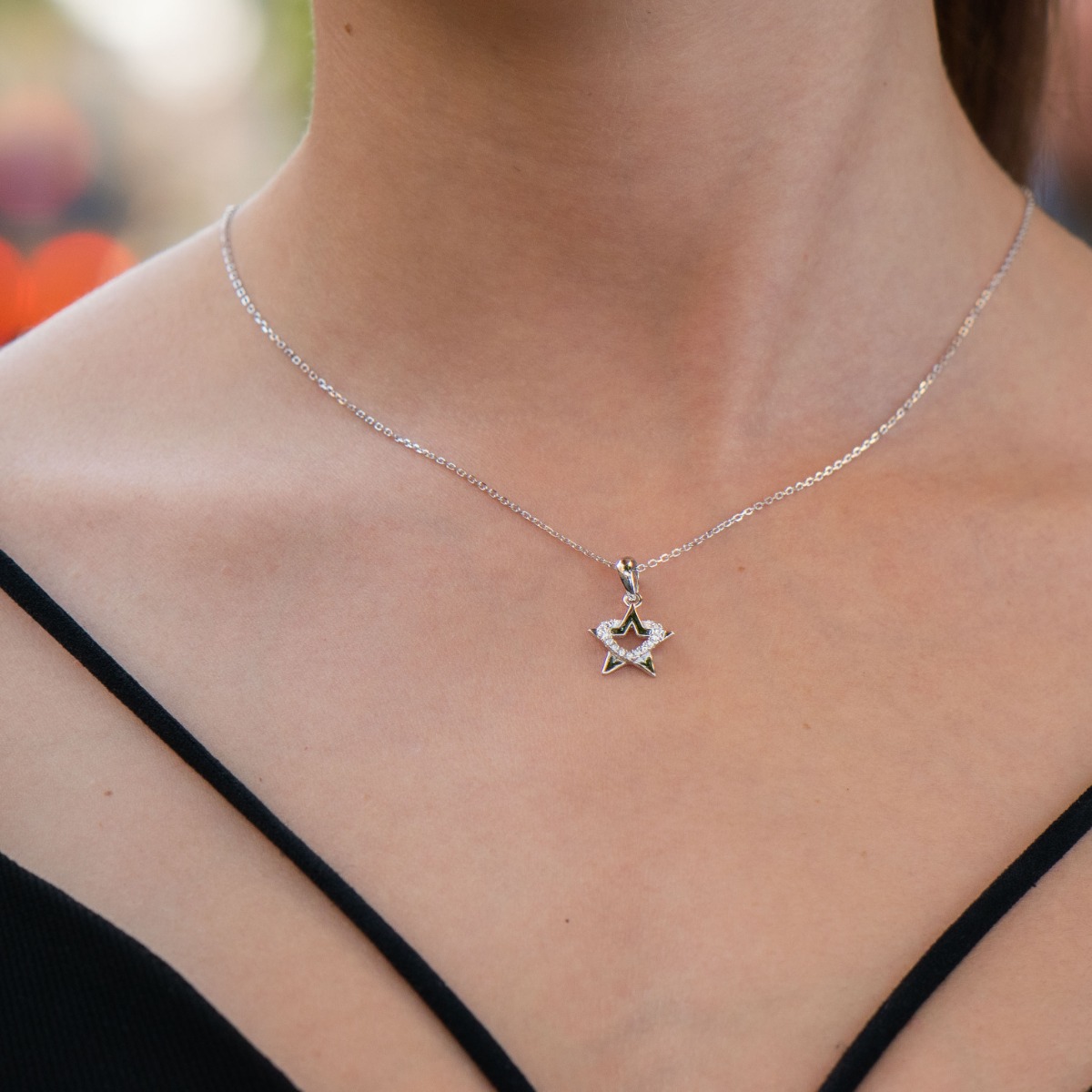 An elegant silver necklace with an accent of a spectacularly shaped star. Stylish composition made entirely of soft rhodium silver, enhanced by the shine of white zircons.