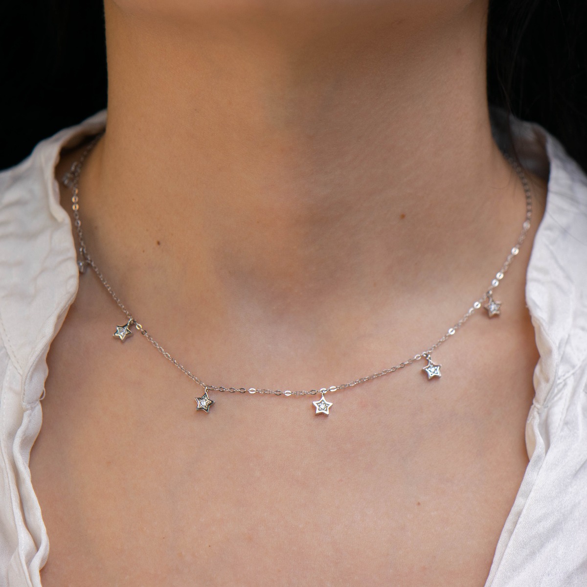 Extremely fine silver necklace with small star elements and delicate workmanship entirely of shiny rhodium-plated silver.