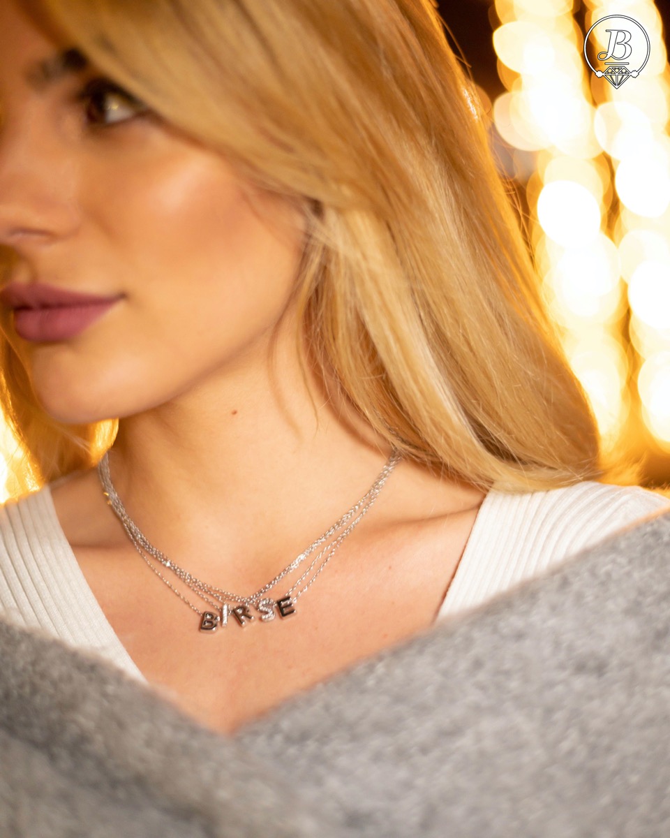 Finely crafted silver letter T necklace for women, all covered with glittering zircons. An attractive piece of jewelry in which the delicate beauty of rhodium-plated silver is skilfully combined with the brilliance of zircons.