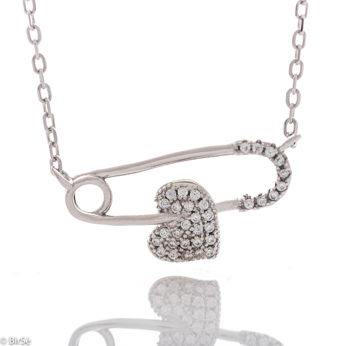 A spectacular silver necklace with delicate craftsmanship and a stylish design, combining rhodium-plated silver with an elegant safety pin element and a sparkling heart with zircons.