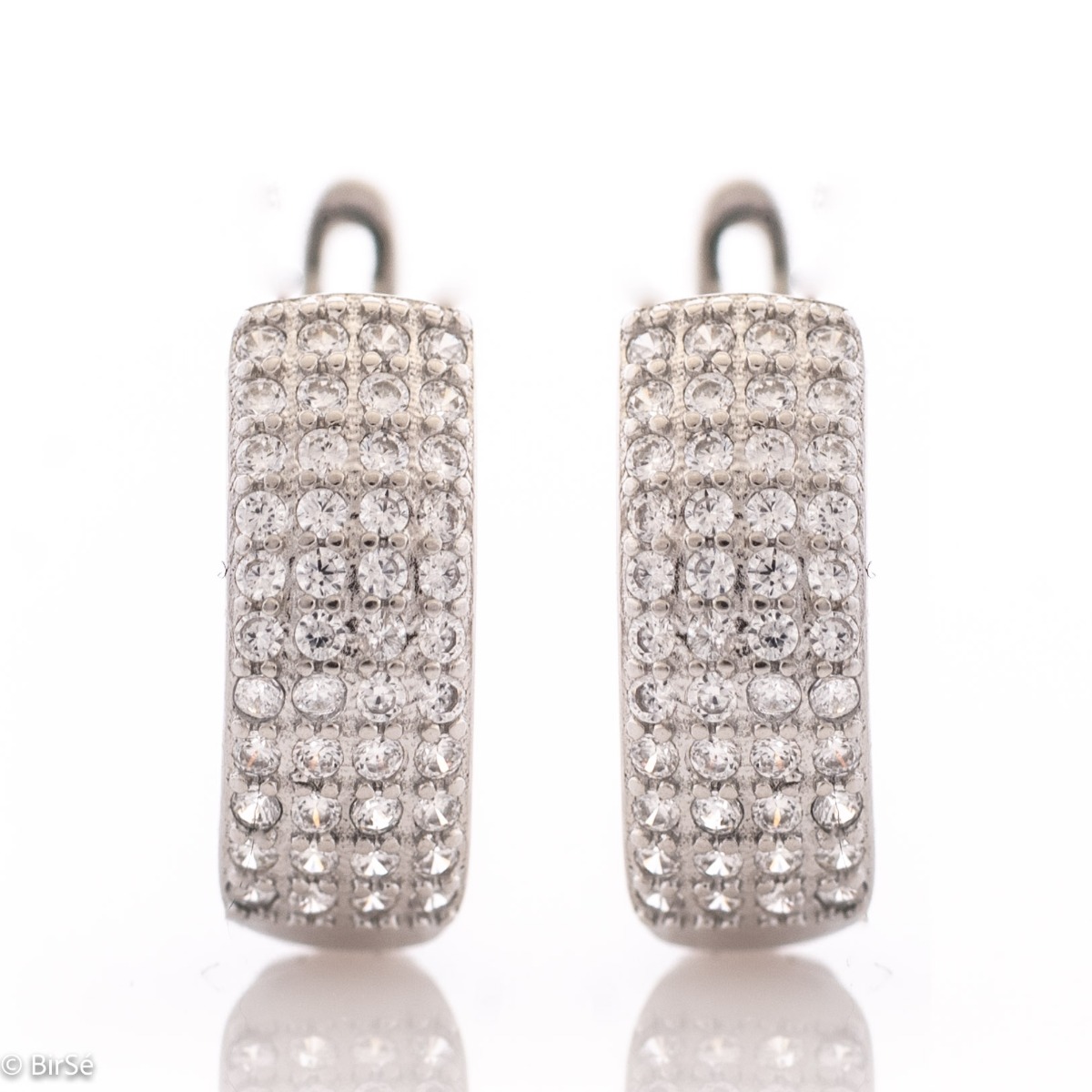 Captivating women's earrings with a spectacular shape and modern design. Crafted entirely from rhodium-plated sterling silver, with a comfortable English clasp and added dazzling zircons, they are the perfect piece of jewelery for any outfit.