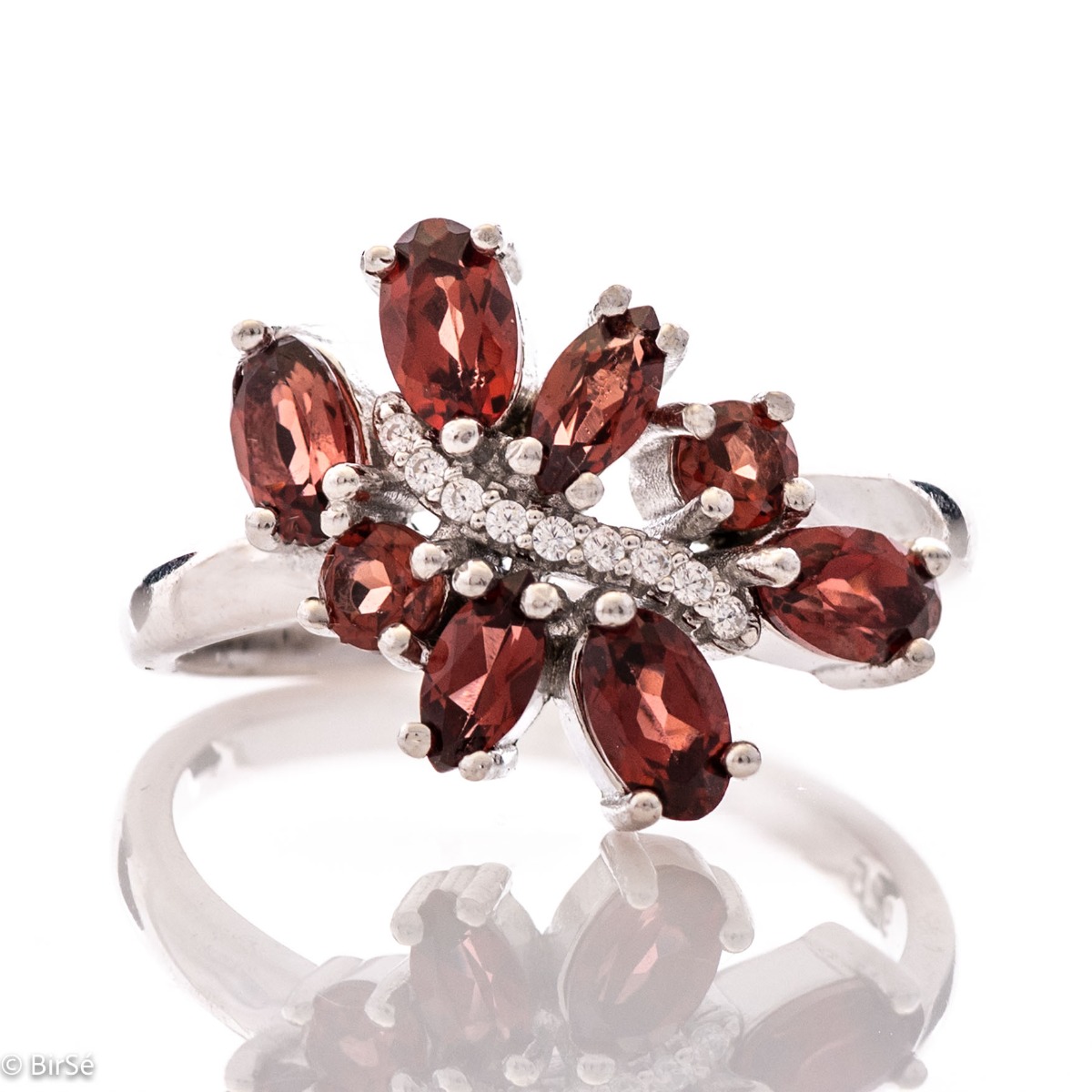 Delicately elegant silver ring with a charming look and innovative design. Stylish craftsmanship from a fine combination of rhodium-plated silver with charming natural garnet stones and delicate zircons.