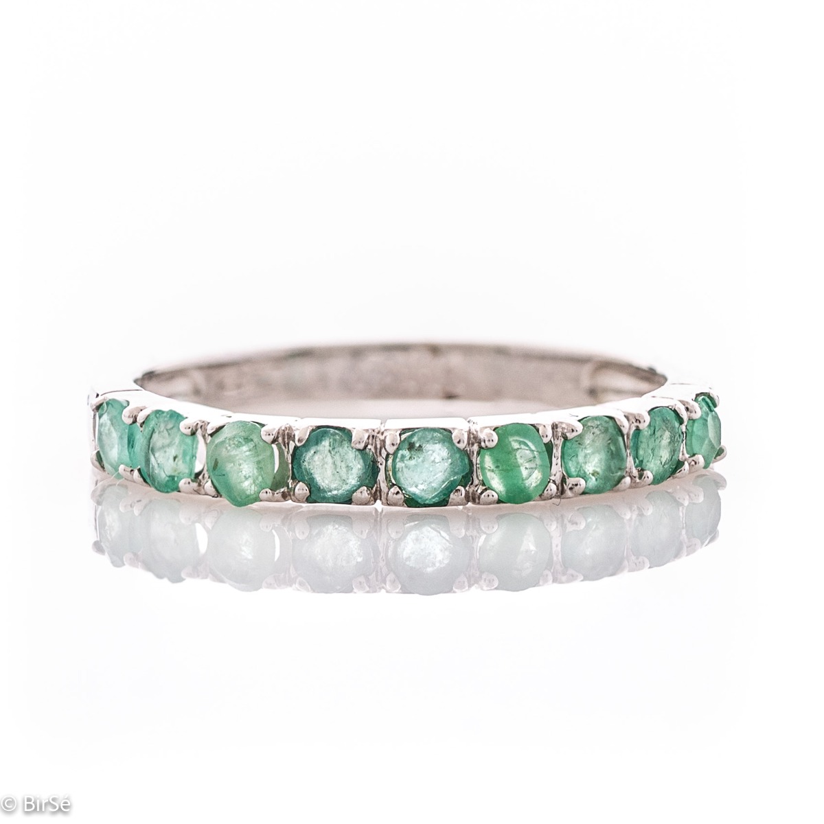 Finely crafted fine rhodium silver women's ring with a row of charming natural emeralds.