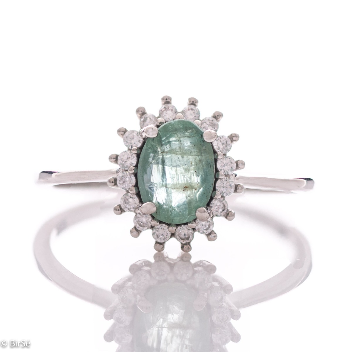 A radiant women's ring with delicate craftsmanship entirely in rhodium-plated silver, complemented by a unique natural emerald stone and the sparkle of fine zircons. Part of an exclusive set with a delicate pendant and earrings.