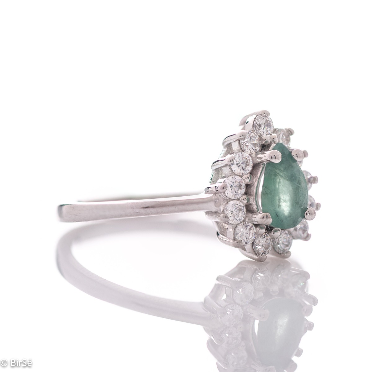 Delicate women's ring with a radiant natural emerald stone, in a beautiful teardrop shape, surrounded by sparkling zircons and made entirely of rhodium-plated silver.