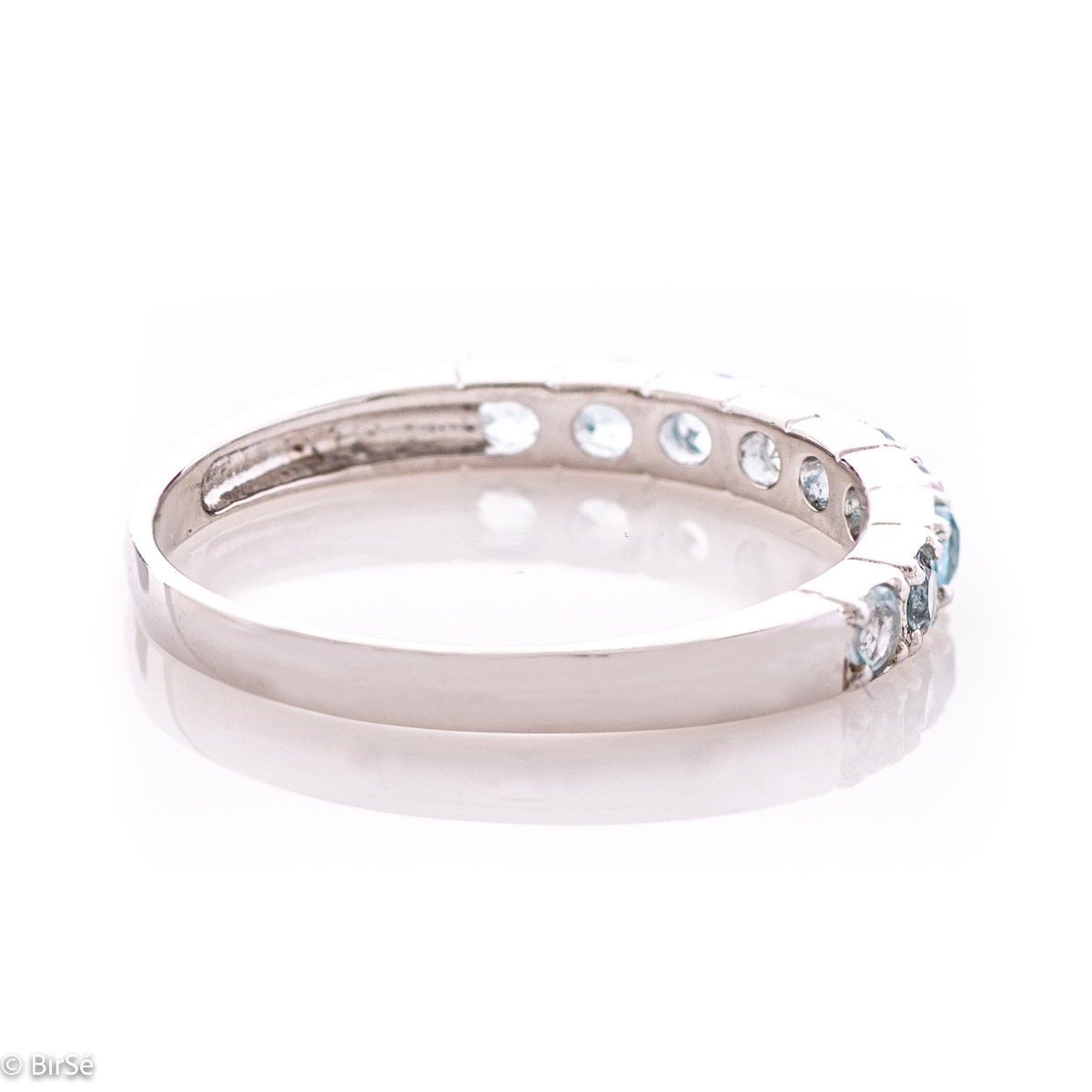 A dazzling ring of beautiful rhodium-plated sterling silver and a row of lovely sky blue topazes.