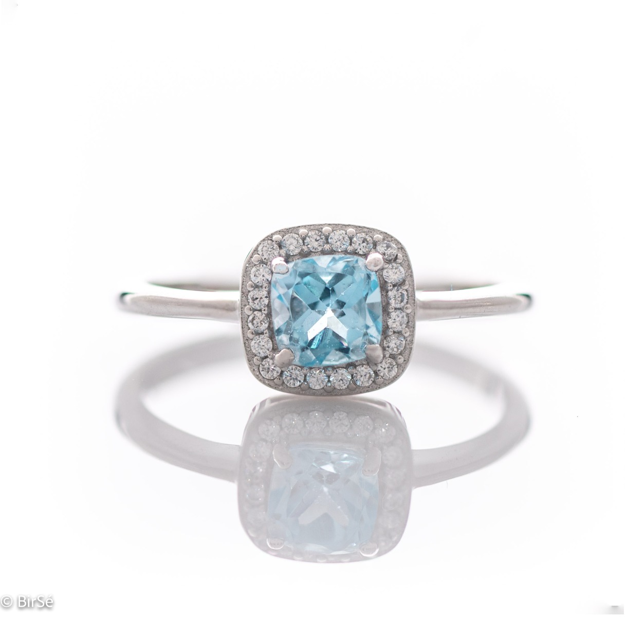 Tempting ring of rhodium-plated silver and natural blue topaz in the exquisite embrace of zircon stones.