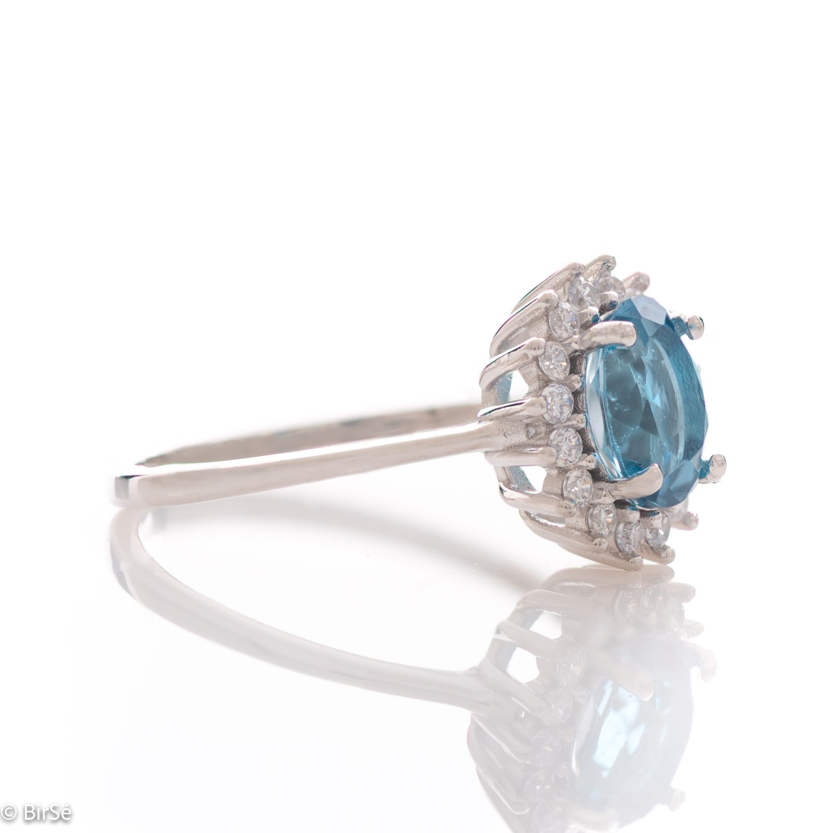 Tempting ring of rhodium-plated silver and natural London topaz in the exquisite embrace of cubic zirconia stones. In a charming set with a pendant and earrings.