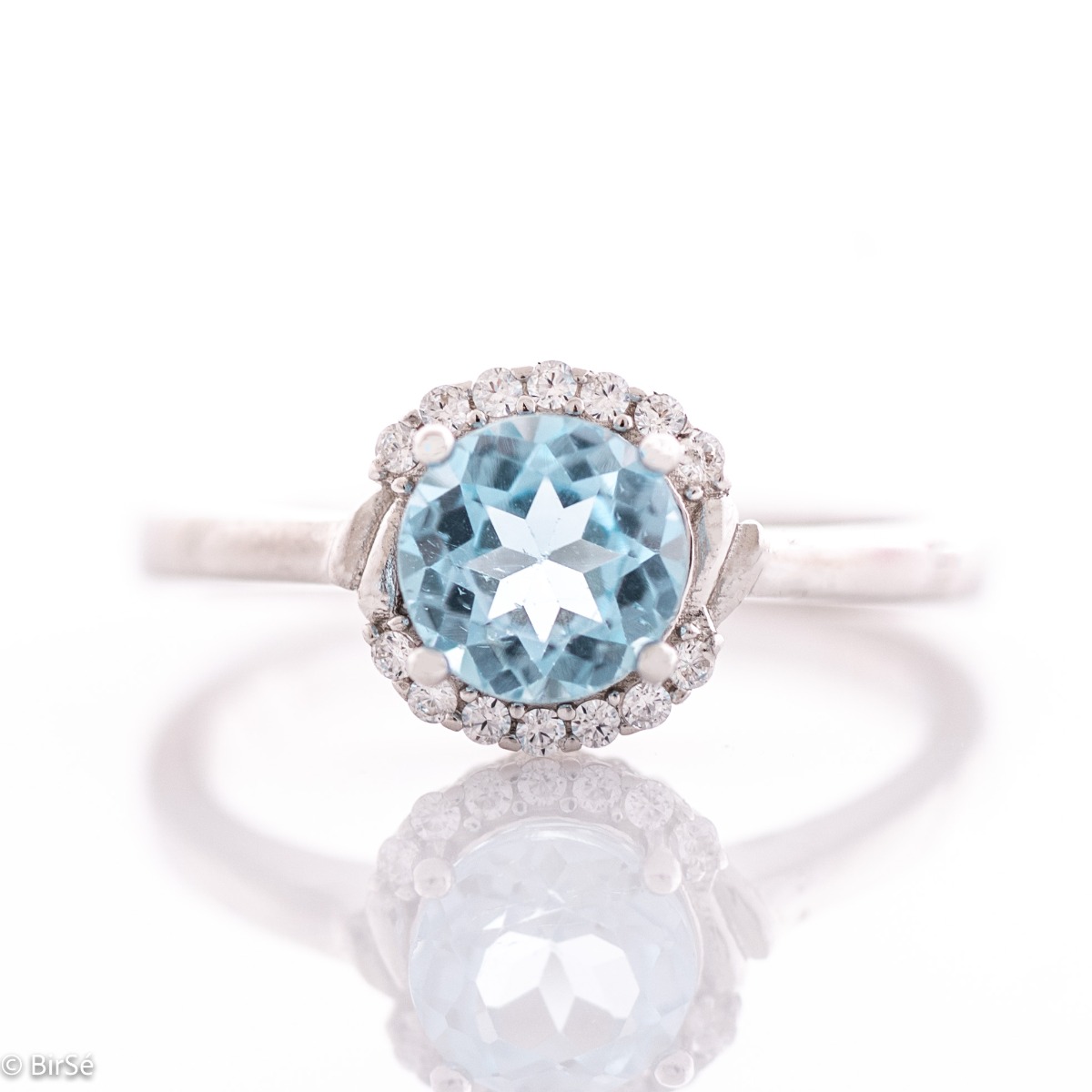 Finely crafted sterling silver ring with masterly detailing and a tempting combination of dazzling blue topaz and delicate zircons. Can be combined with earrings and pendant to the set.