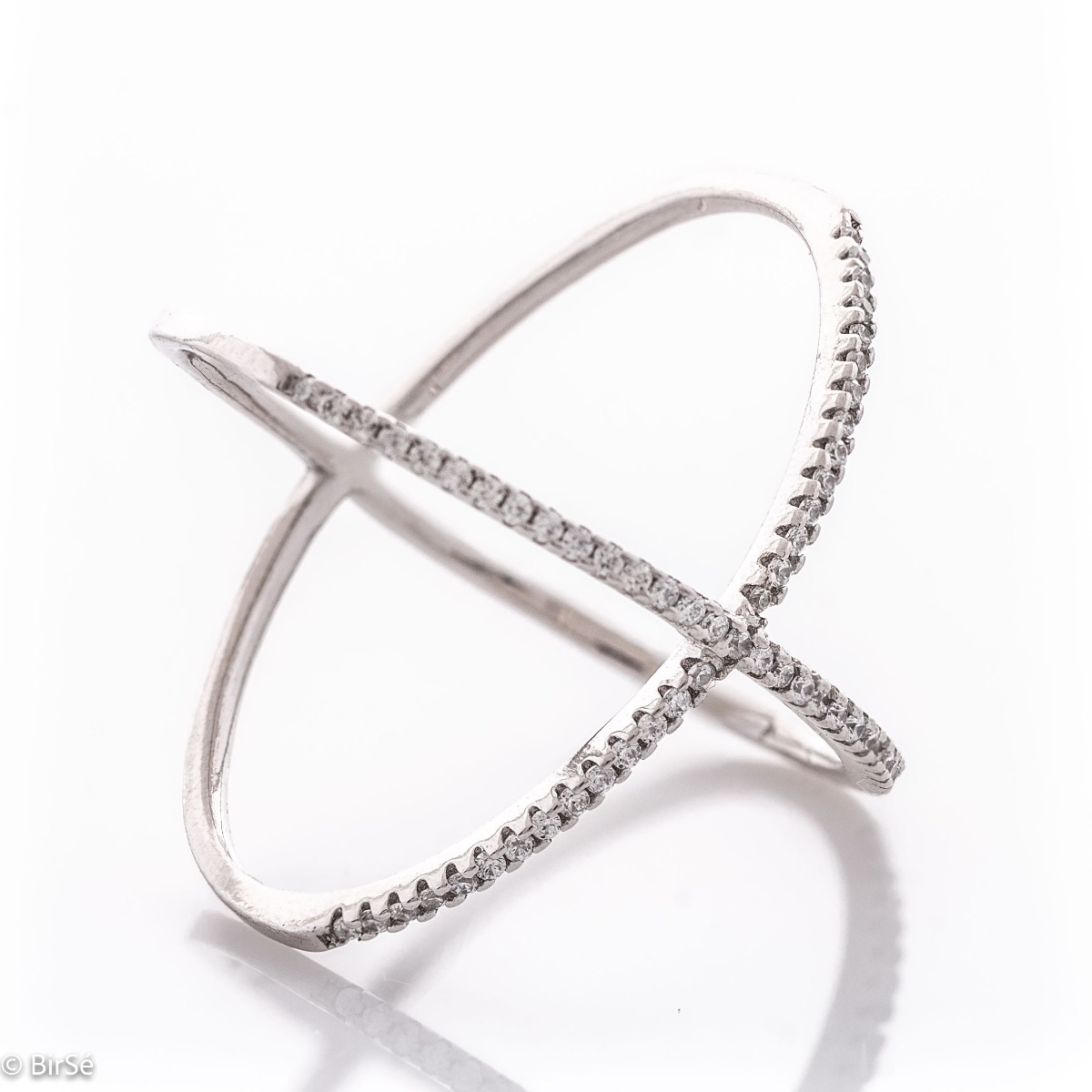 Extravagant X-shaped women's ring, entirely made of fine rhodium-plated silver. The modern design combined with the dazzling charm of zircons make the ring an irresistible temptation.