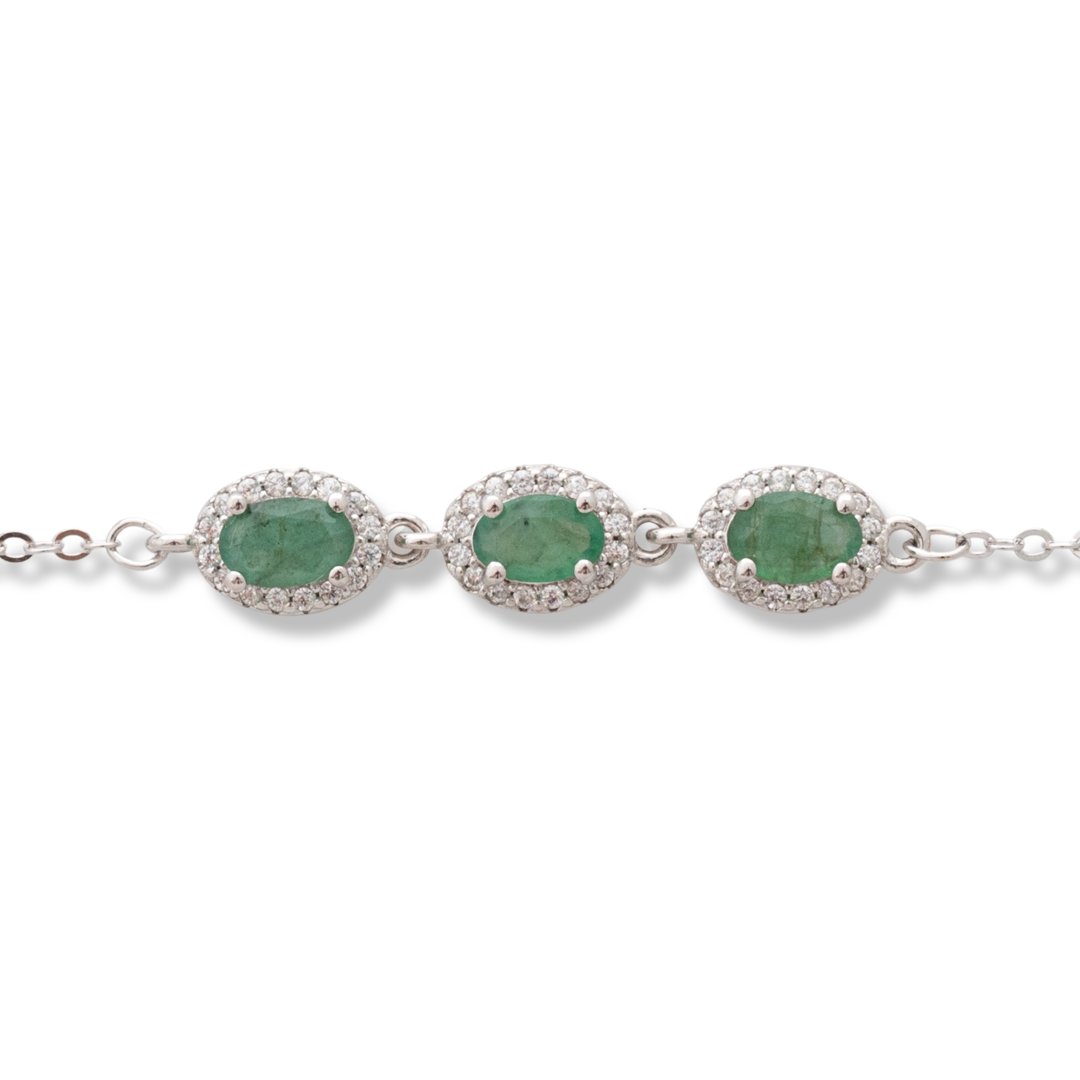 An elegant women's bracelet made of soft silver with natural emerald stones, decorated with exquisite and subtle elements and sparkling zircons. The bracelet has an extension, for greater convenience when adjusting the length.