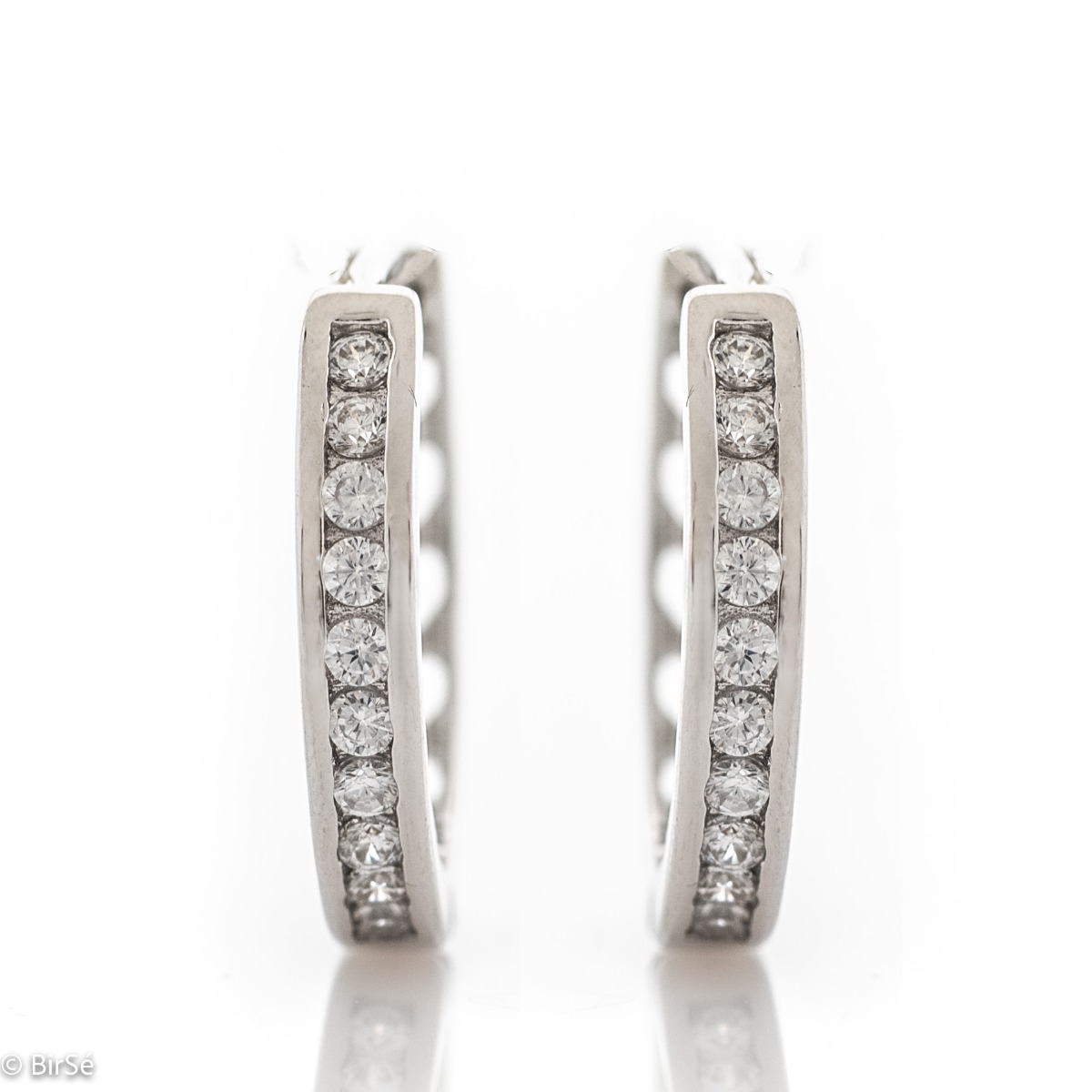 Graceful ladies' earrings - rings made of rhodium-plated silver with a comfortable English clasp. The front of the earrings is decorated with dazzling zircons. Suitable jewelry for your everyday life.