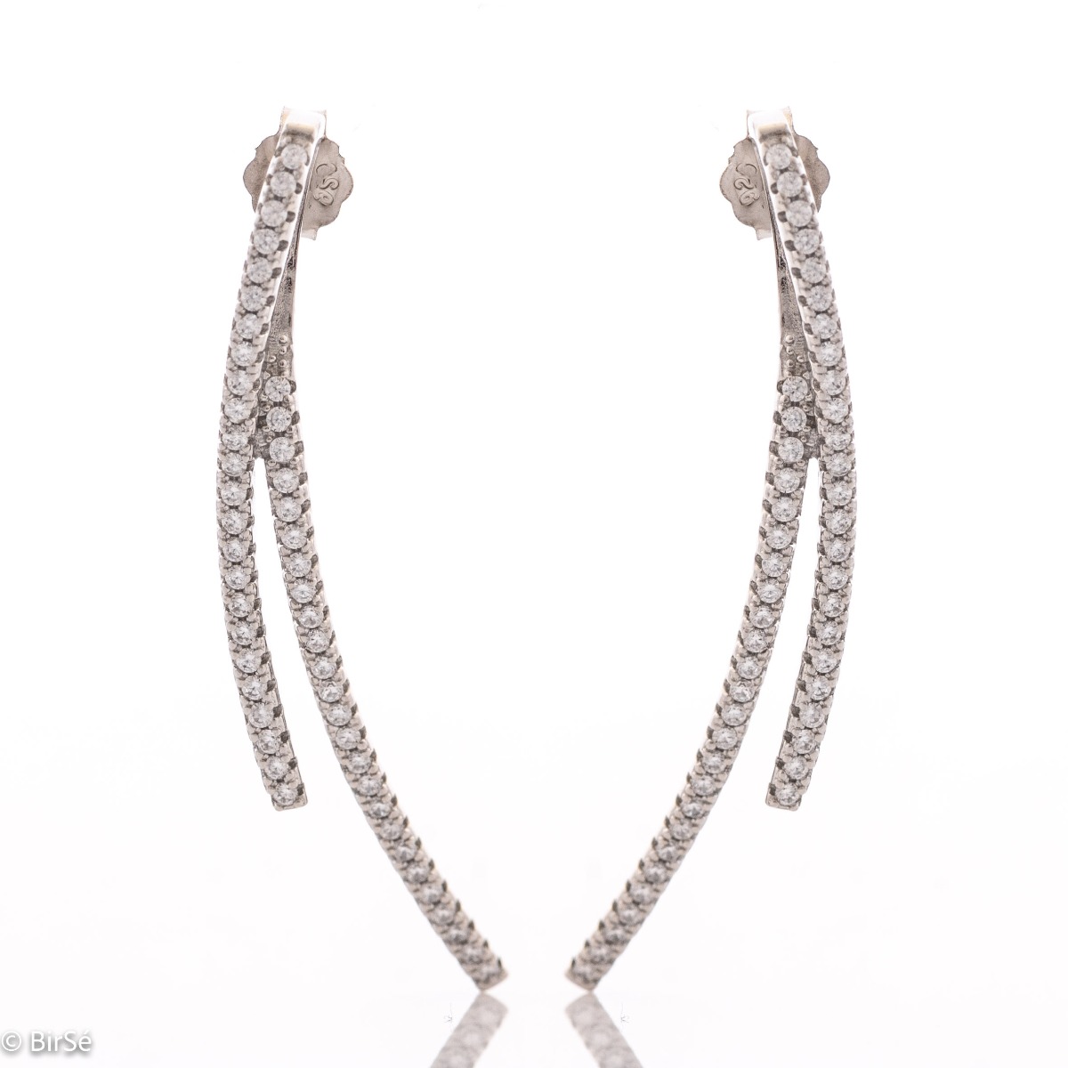 Feminine and tempting earrings cast from rhodium silver with captivating zircons adorning the spectacular jewel. The look of delicate earrings has an interesting design solution. The fastening is with a pin, for greater convenience and comfort.