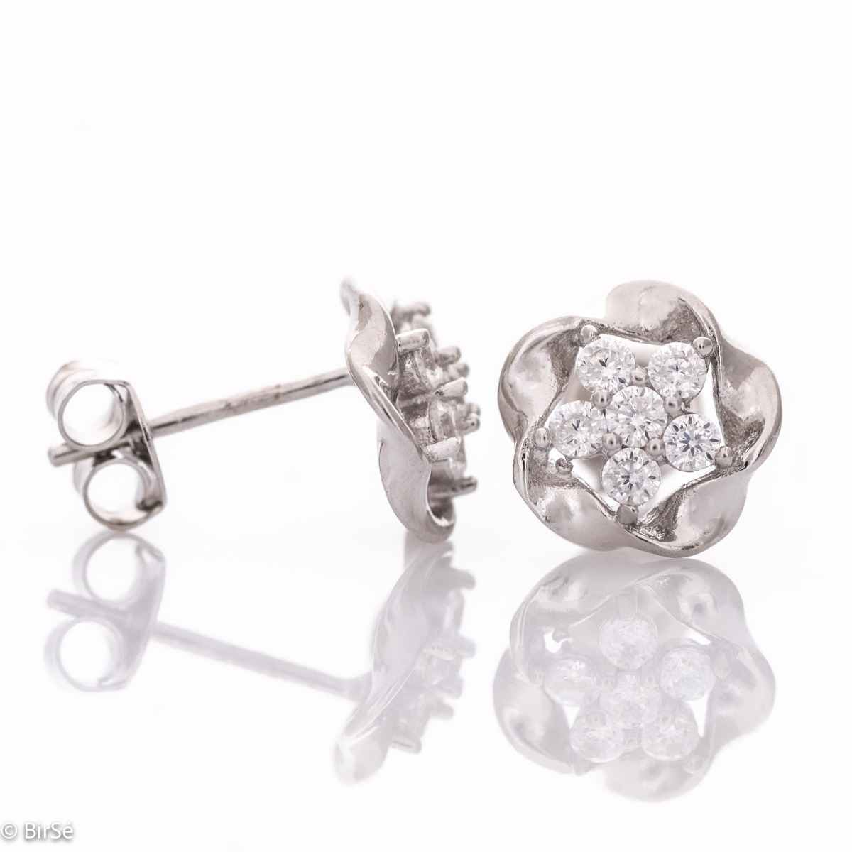 Captivatingly exquisite earrings with a charming design in rhodium silver, elegantly decorated with zircons. Pin fastening for convenience and security. They are beautifully combined with jewelry made of silver and zircons.