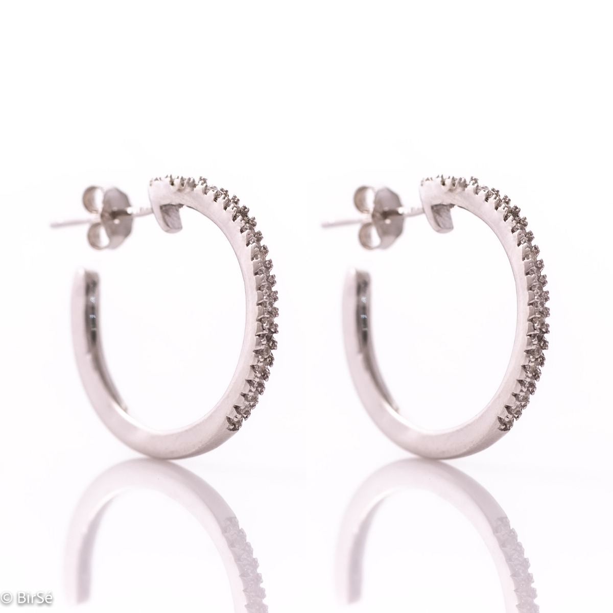 Elegant earrings in beautiful rhodium silver hoops with delicate sparkling zircons and pin fastening.