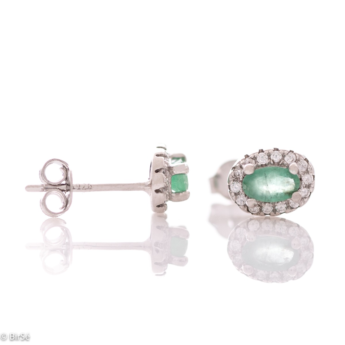 Stylish women's earrings with an elegantly shaped pattern of rhodium-plated silver and a natural emerald stone, beautifully surrounded by dazzling zircons.