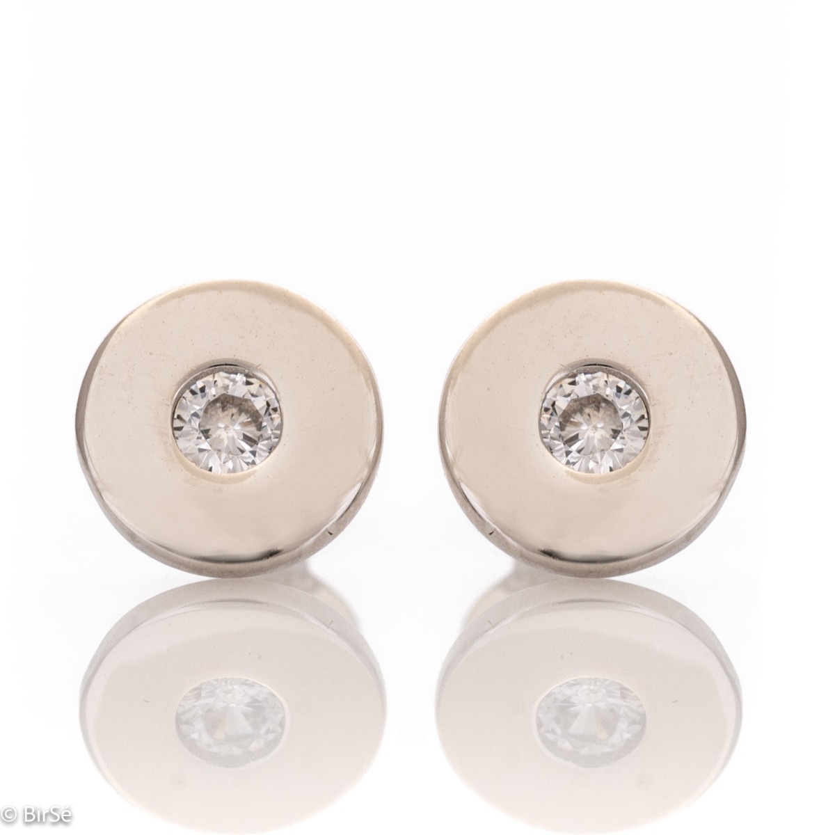 Delicate women's earrings in fine rhodium-plated silver, with an elegantly shaped circle, in the center of which charmingly sparkles a zircon. The earrings are fastened with a pin - extremely comfortable and practical. A suitable gift for any stylish lady