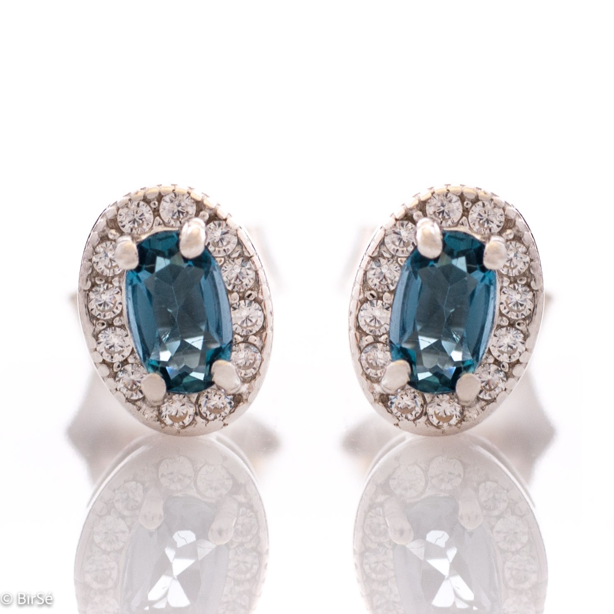 Royal vision - stunning silver earrings with a spectacular look and stud fastening. An elegant composition made of a fine combination of rhodium-plated silver with exquisite London topaz and zircons.