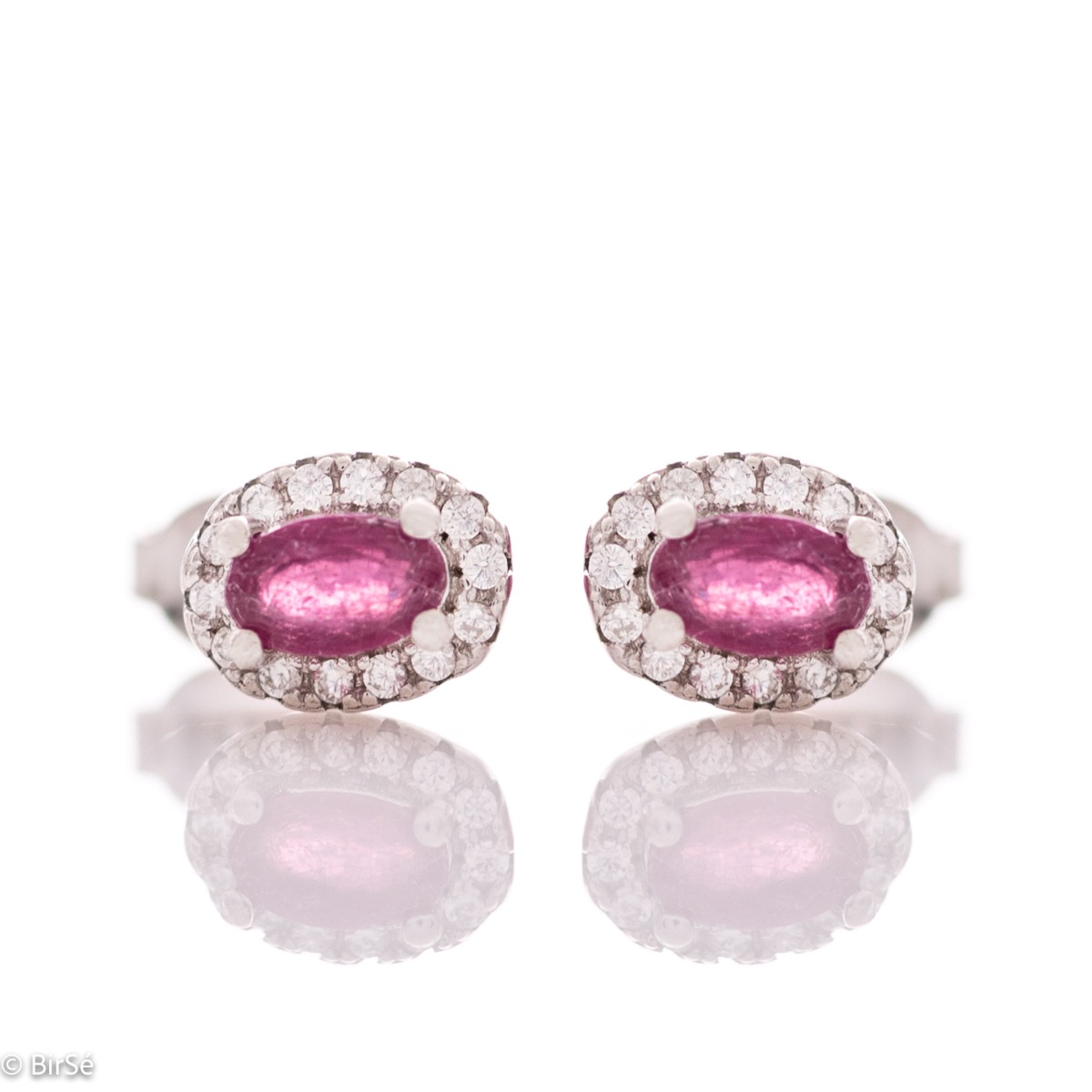 Stylish women's earrings with an elegantly shaped pattern of rhodium-plated silver and a natural ruby ​​stone, beautifully surrounded by dazzling zircons.