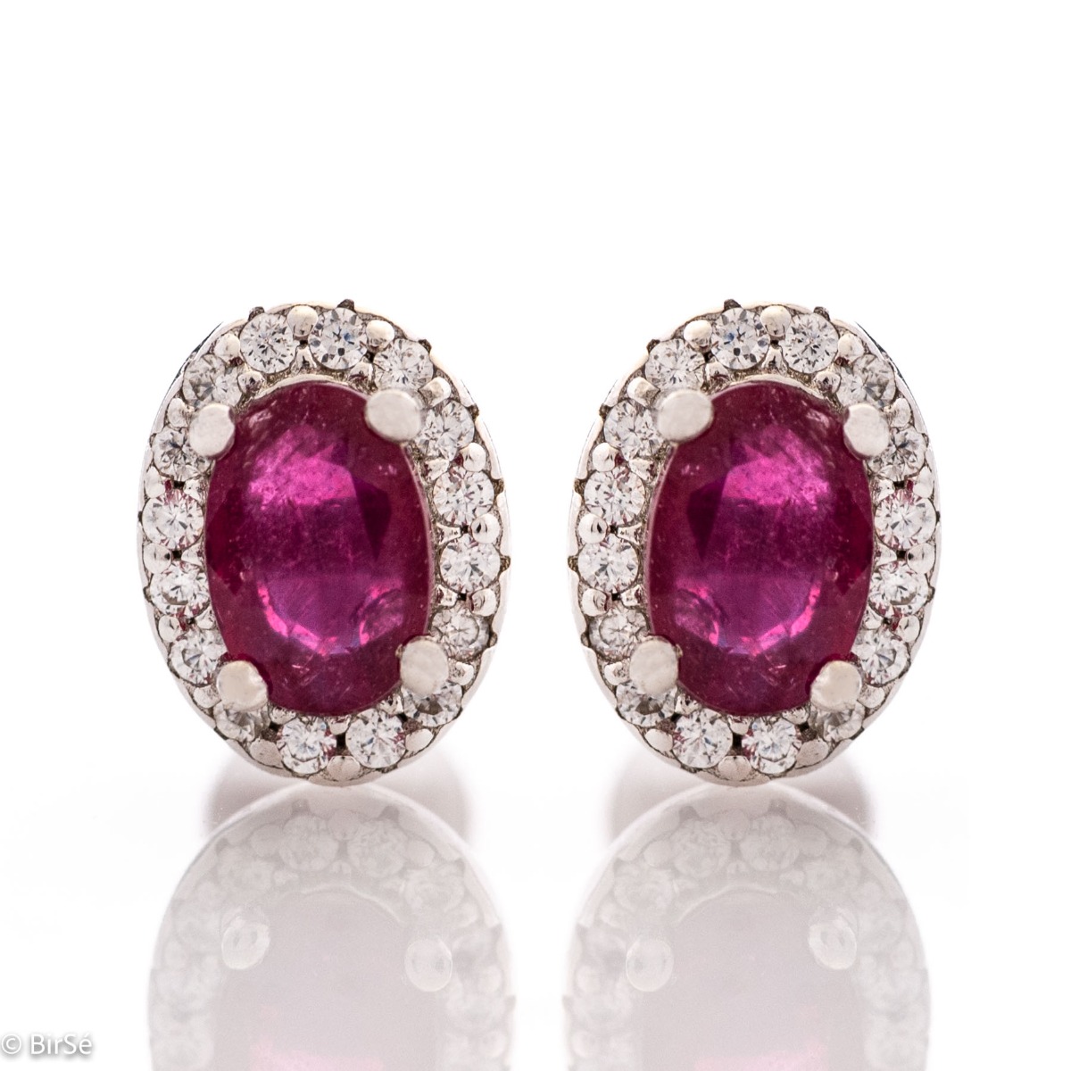 Royal perfection - stunning silver earrings with a spectacular look and pin fastening. An elegant composition made of a fine combination of rhodium-plated silver with a royal ruby ​​and dazzling zircons.