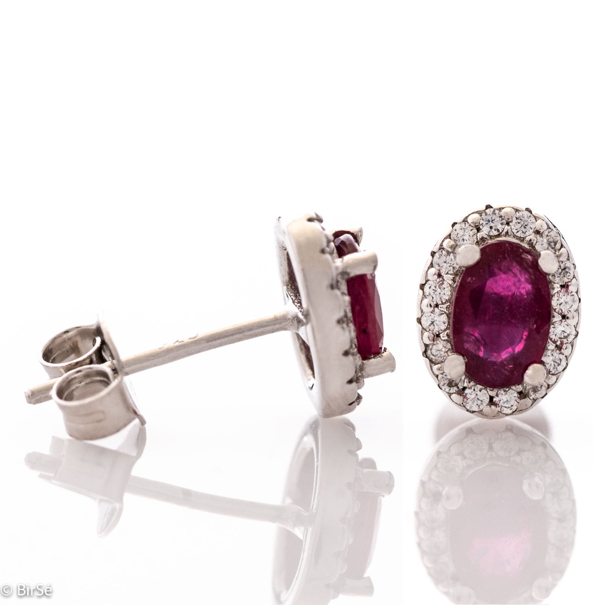 Royal perfection - stunning silver earrings with a spectacular look and pin fastening. An elegant composition made of a fine combination of rhodium-plated silver with a royal ruby ​​and dazzling zircons.