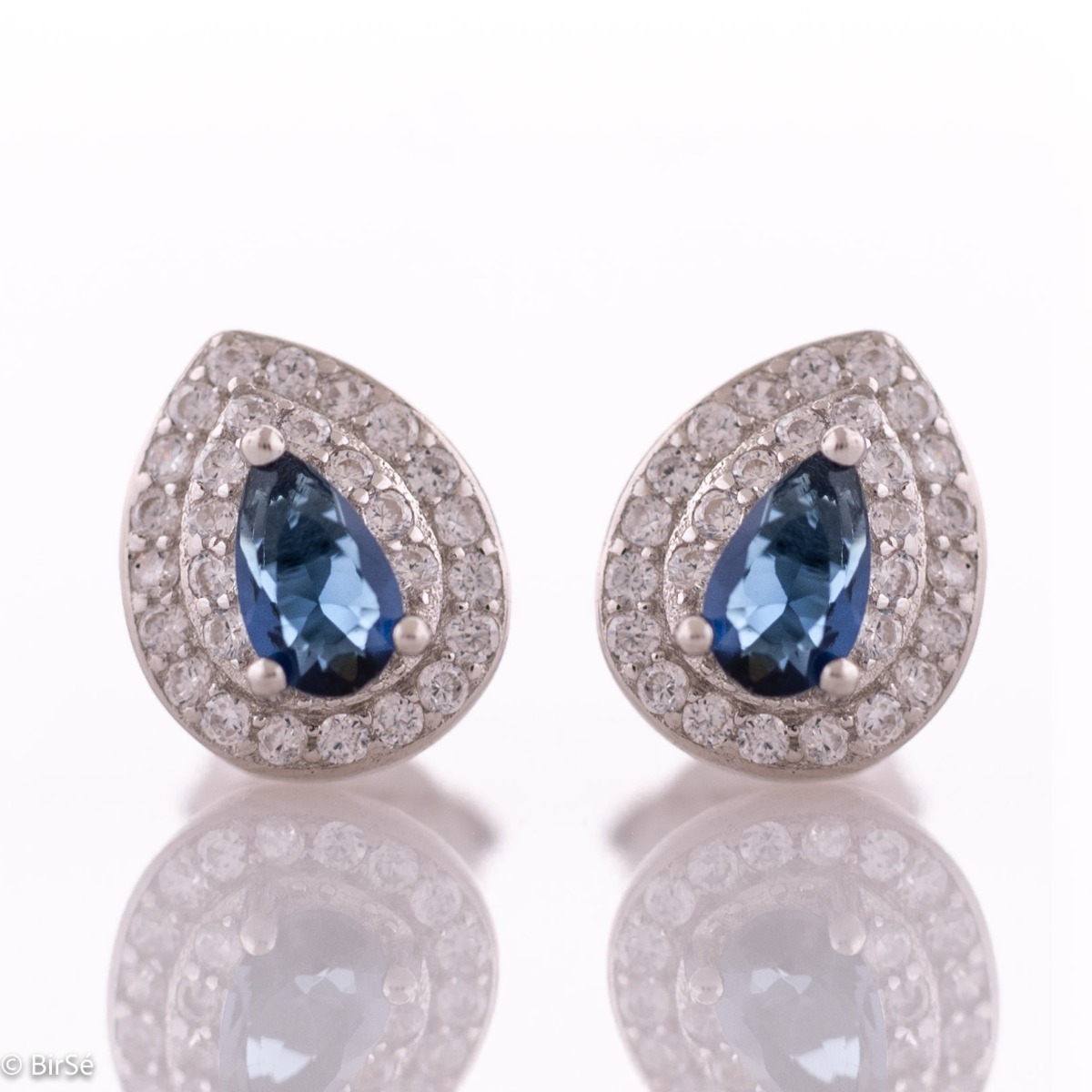 Impressive women's earrings made entirely of rhodium-plated silver with a teardrop shape. In the center, a mesmerizing black cubic zirconia draws the eye with its magical color, while a dazzling double row of cubic zirconias encircling it add a royal char