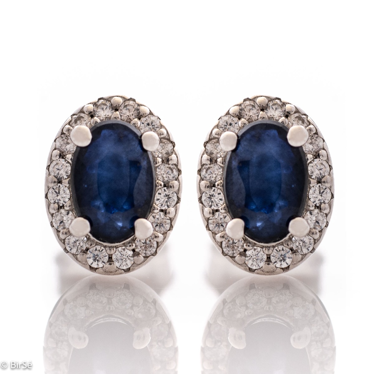 Royal vision - stunning silver earrings with a spectacular look and pin fastening. An elegant composition made of a fine combination of rhodium-plated silver with an exquisite sapphire and dazzling zircons.